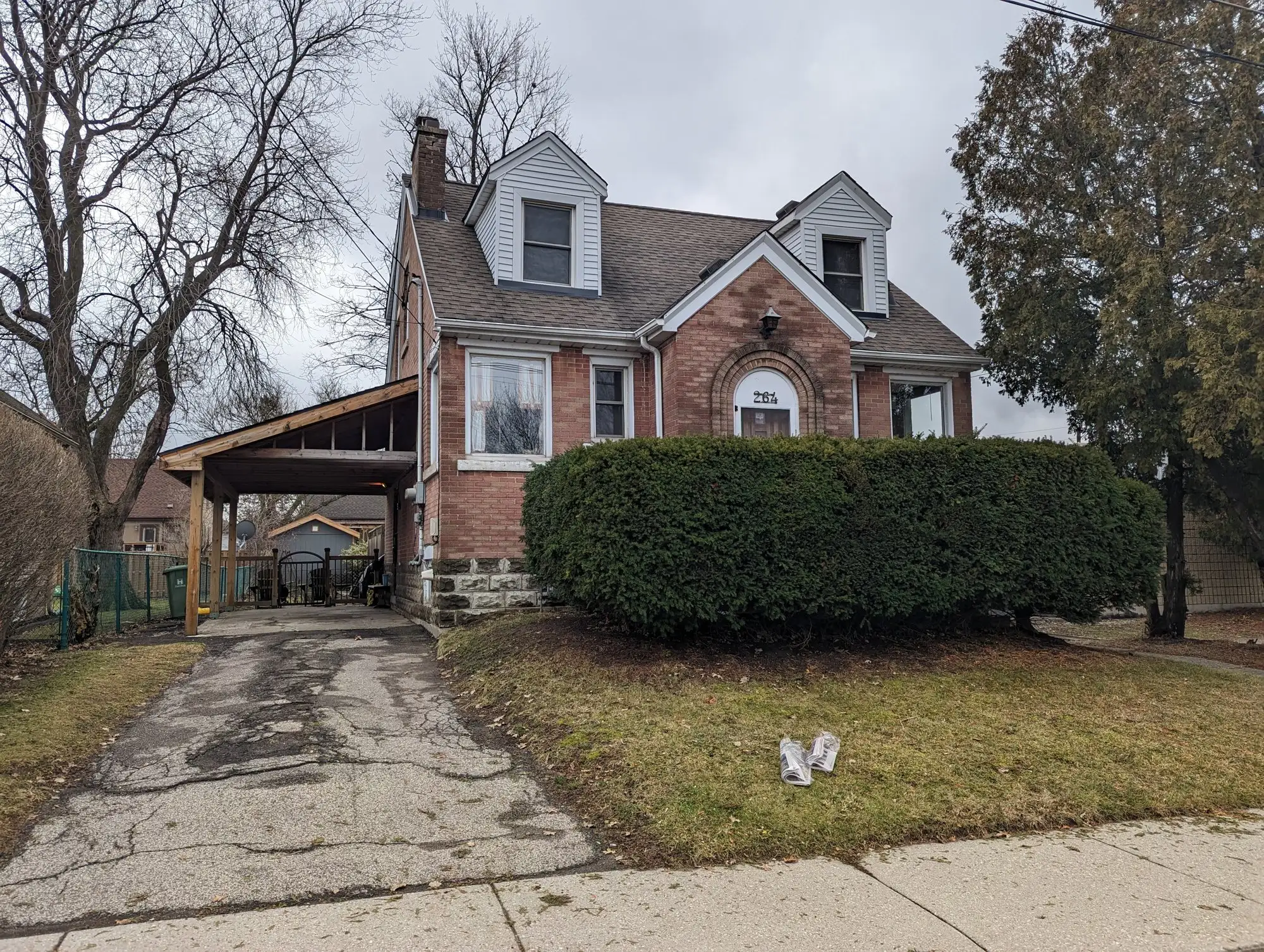 The Hamilton brick two-storey from the street before conversion, the house that became three self-contained units