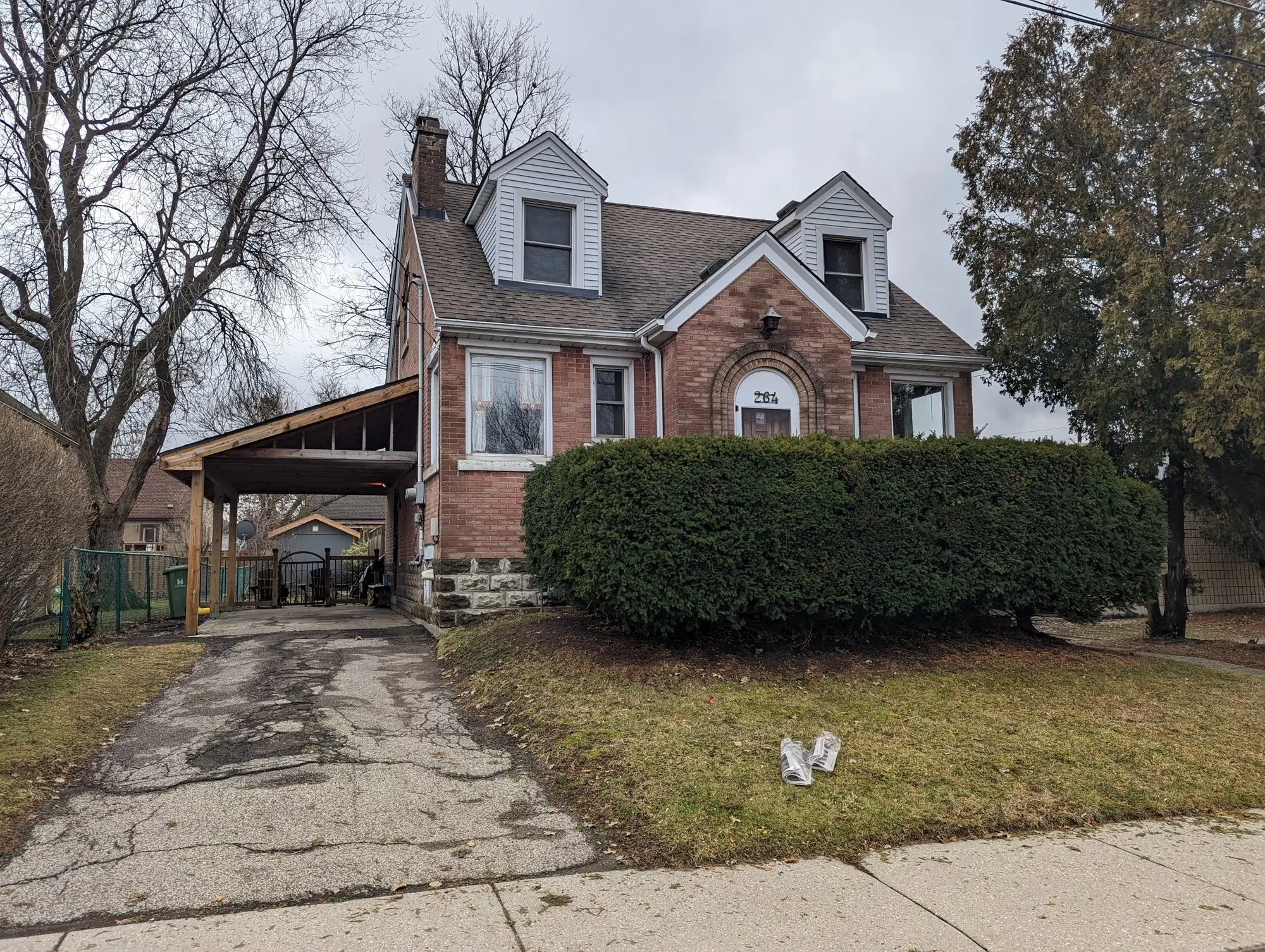 The Hamilton brick two-storey from the street before conversion, the house that became three self-contained units