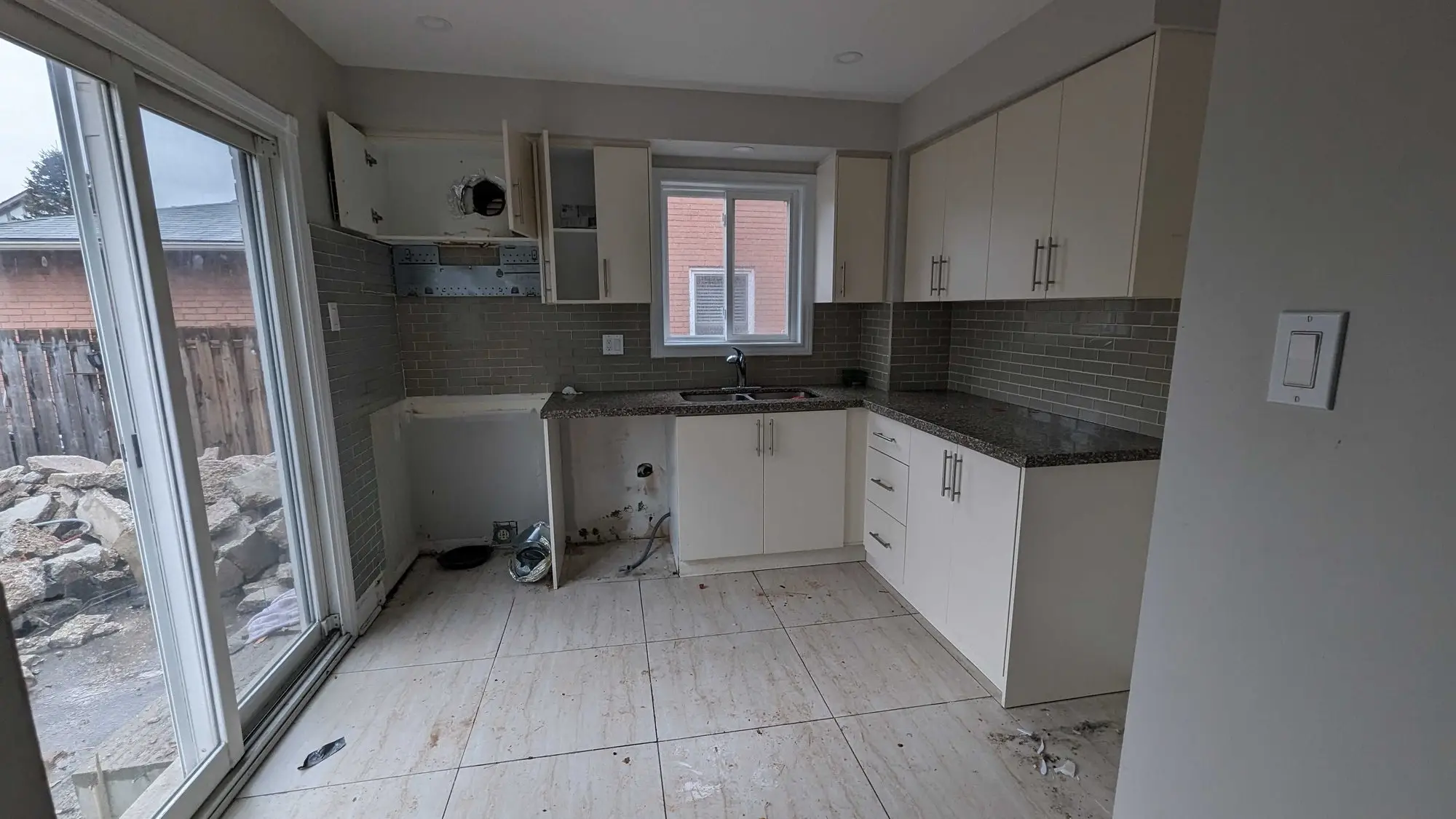 The original kitchen before renovation, with dated cabinets and a small work area