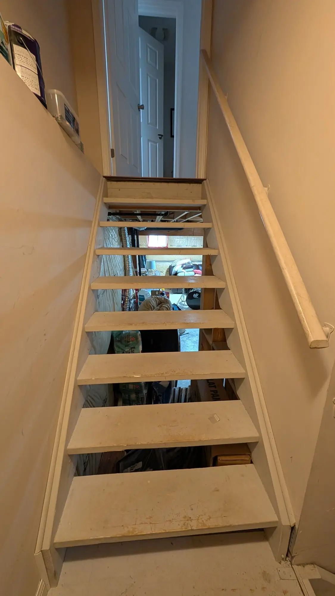 The original open basement stairs before finishing