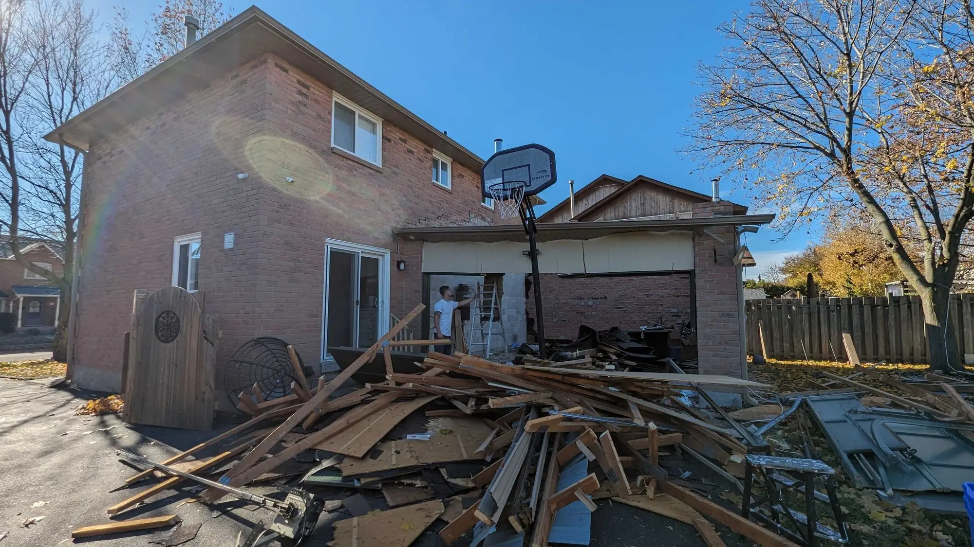 Demolition debris stacked in the yard for removal