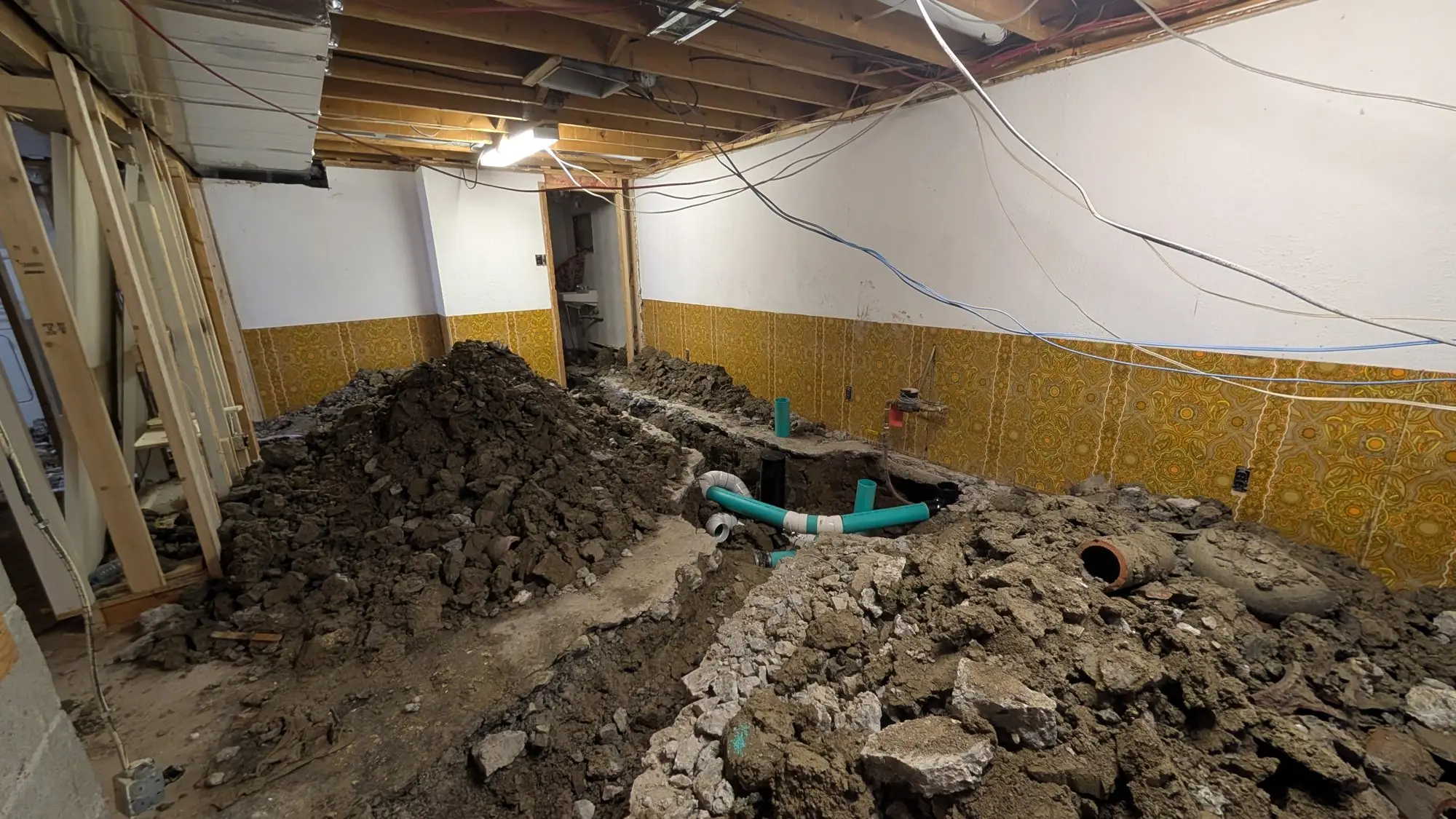 Basement slab opened and trenched for new underground drain lines