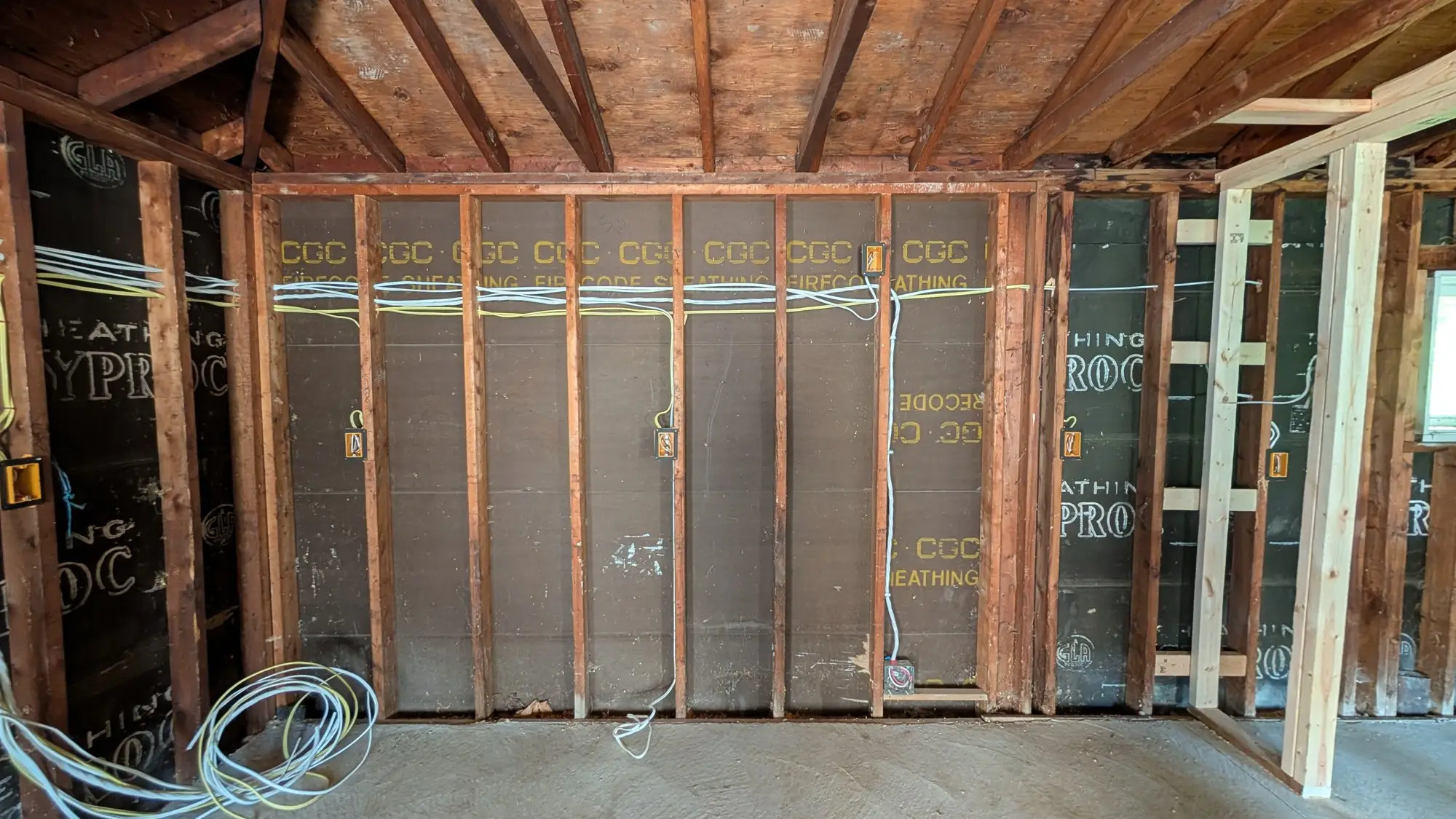 Detached garage stripped back to bare studs before being rebuilt as a studio unit