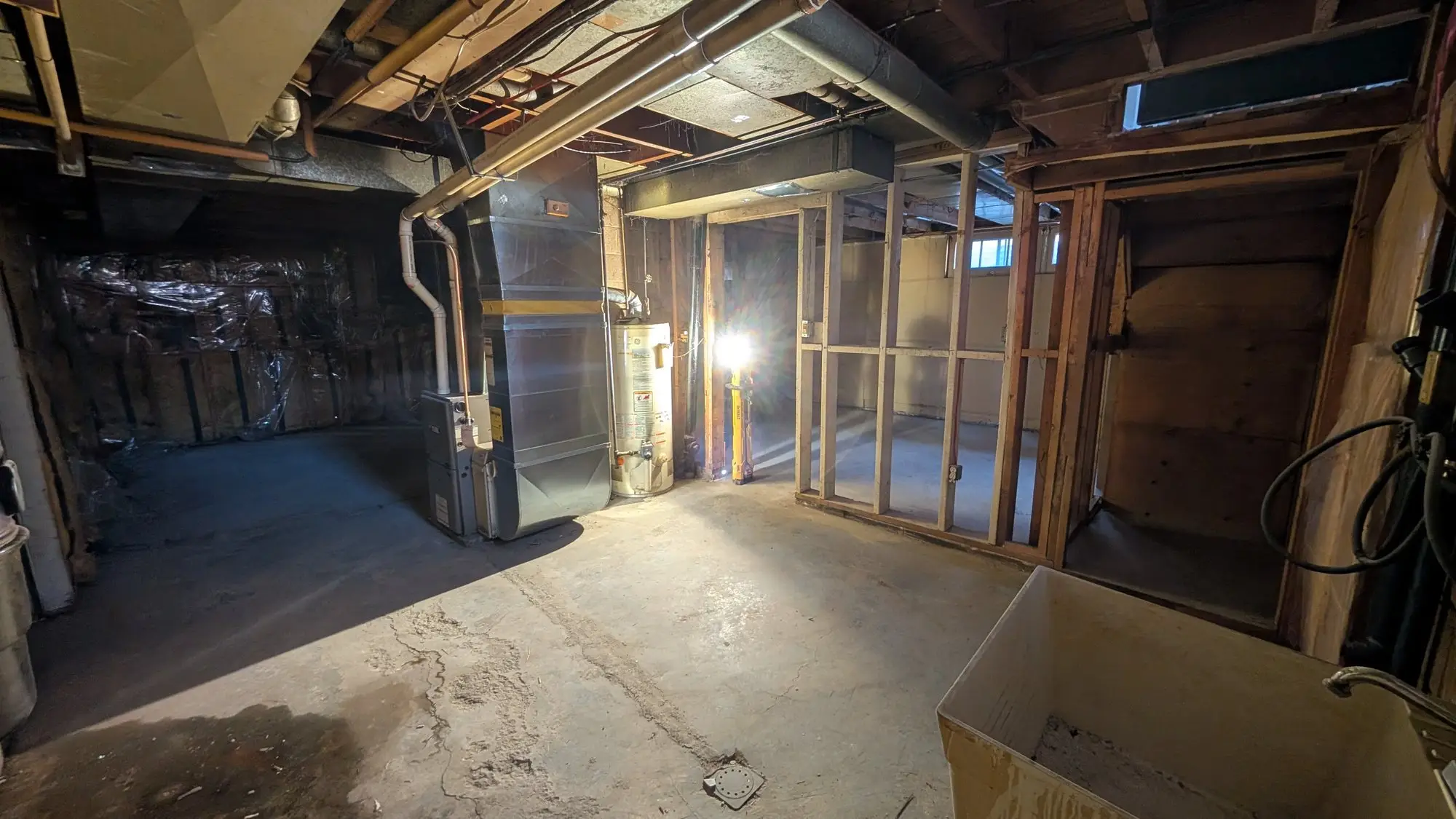 Original mechanical services exposed in the stripped basement