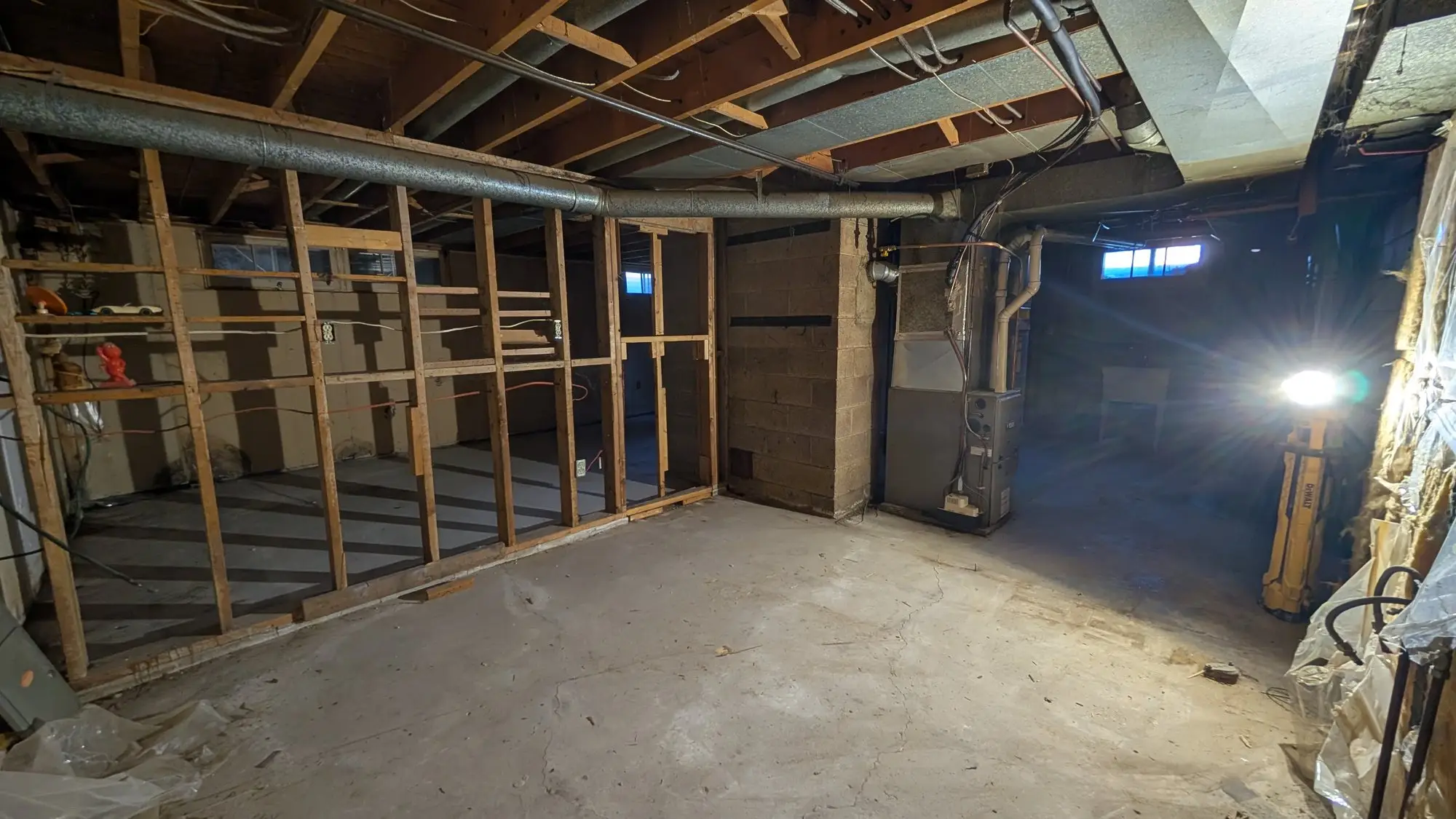 Wide view of the basement after demolition, ready for new framing