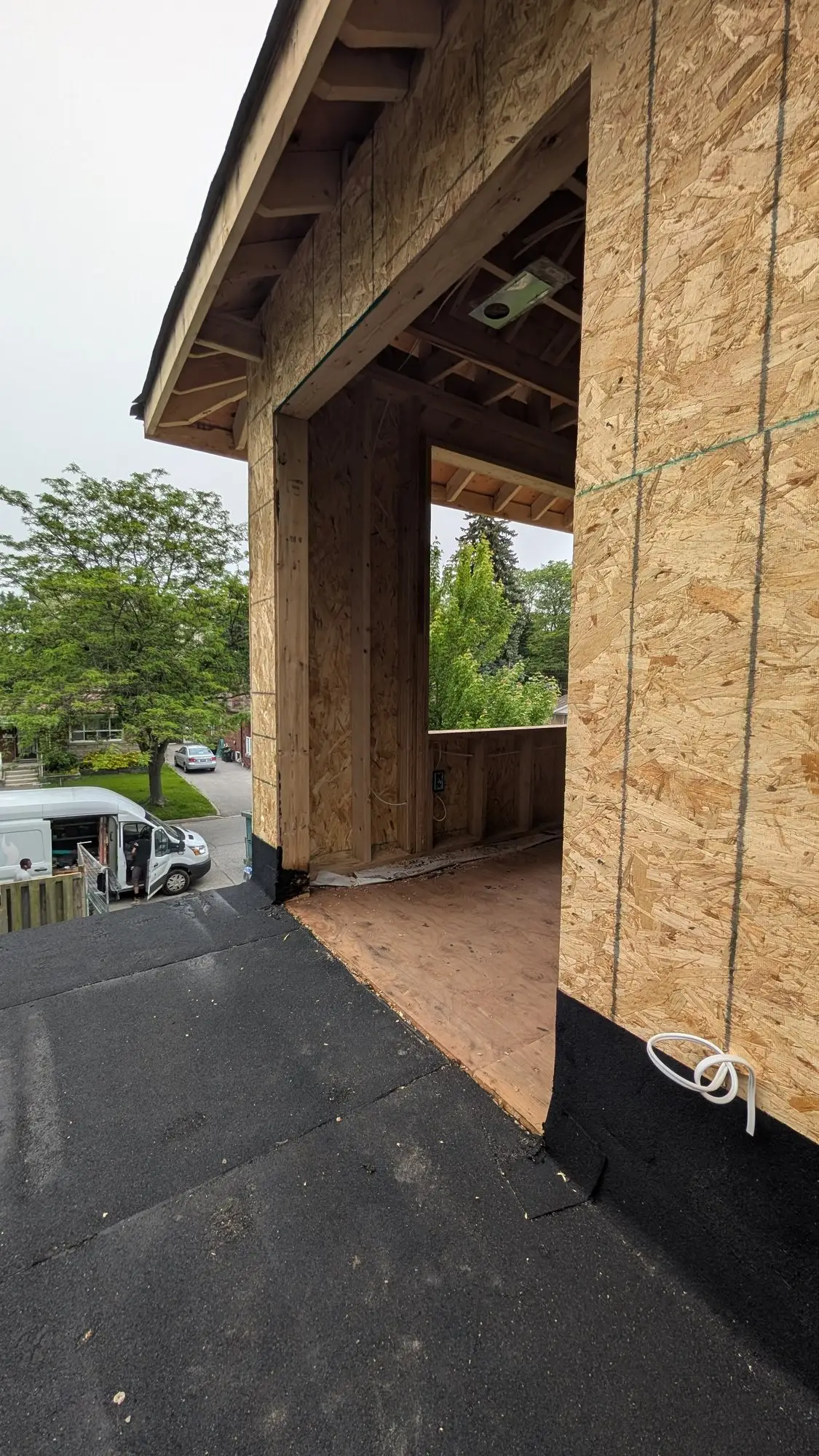 The covered front entry canopy framed in