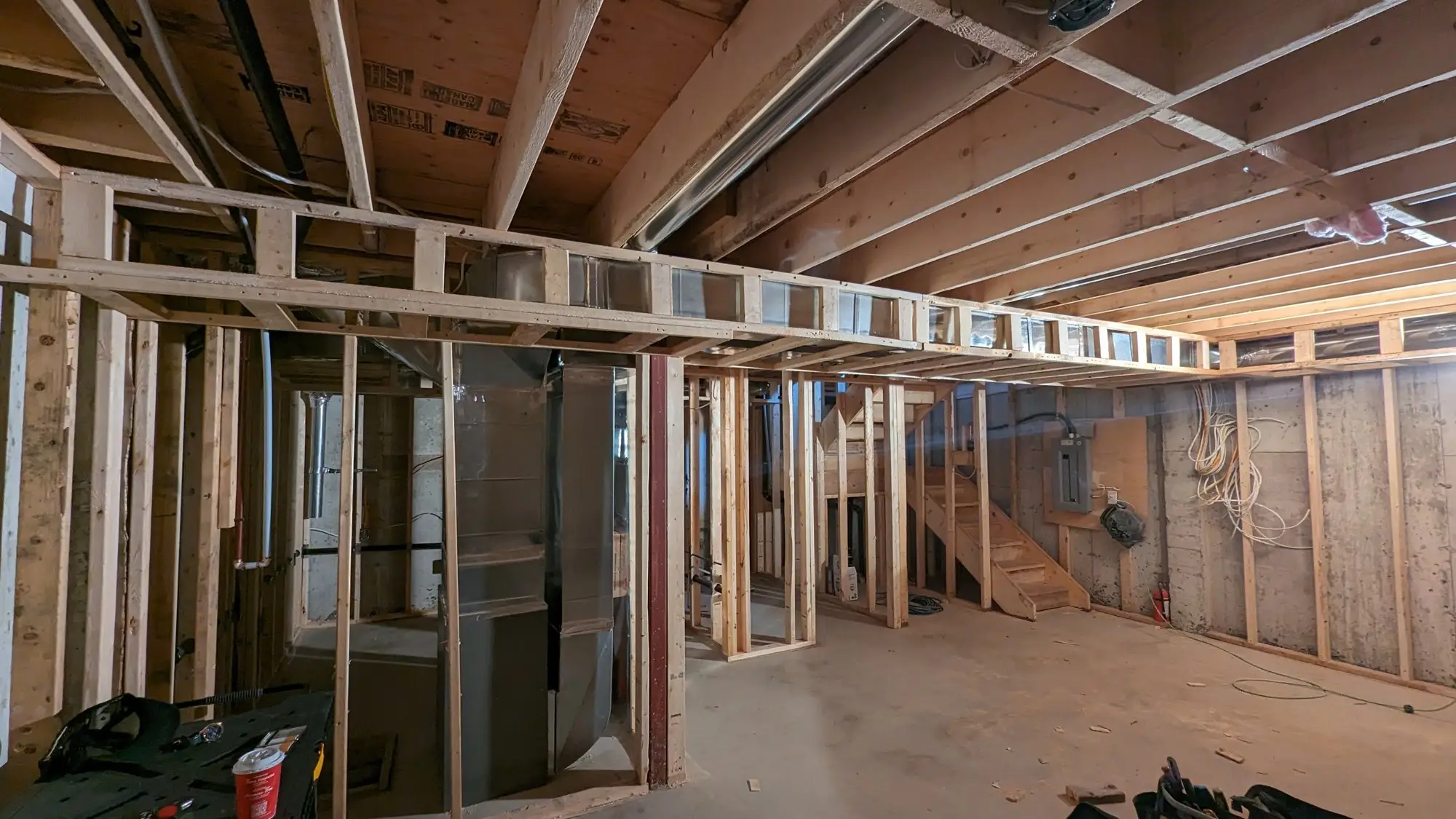 Wide view of the basement with furnace, ducting and rough-in complete