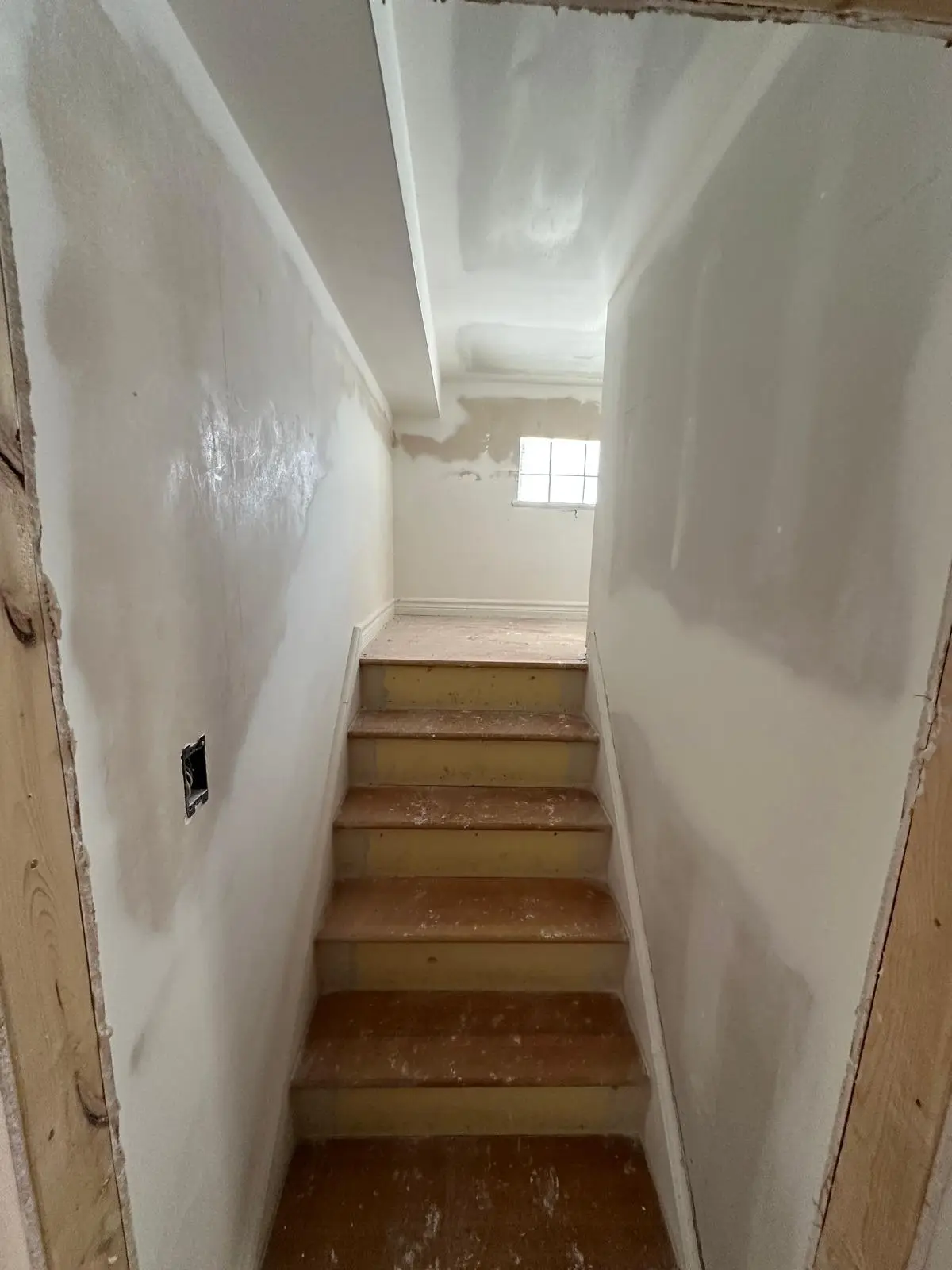 Separated stairwell drywalled, isolating the upper unit from the rest of the house