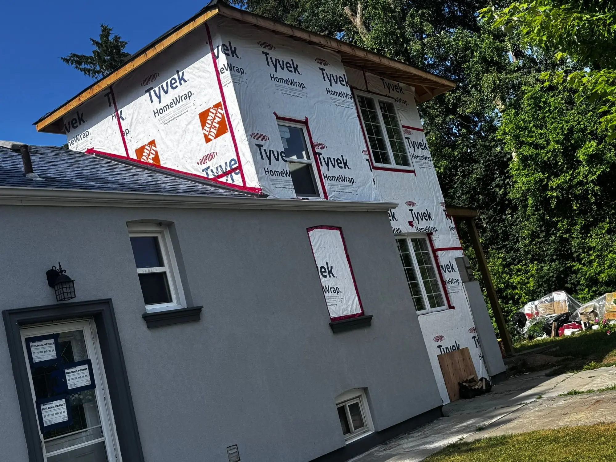Side elevation wrapped, with windows set and the entry canopy framed