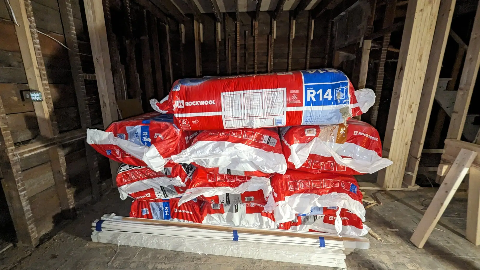 Rockwool R14 batt insulation stacked on site ready to install