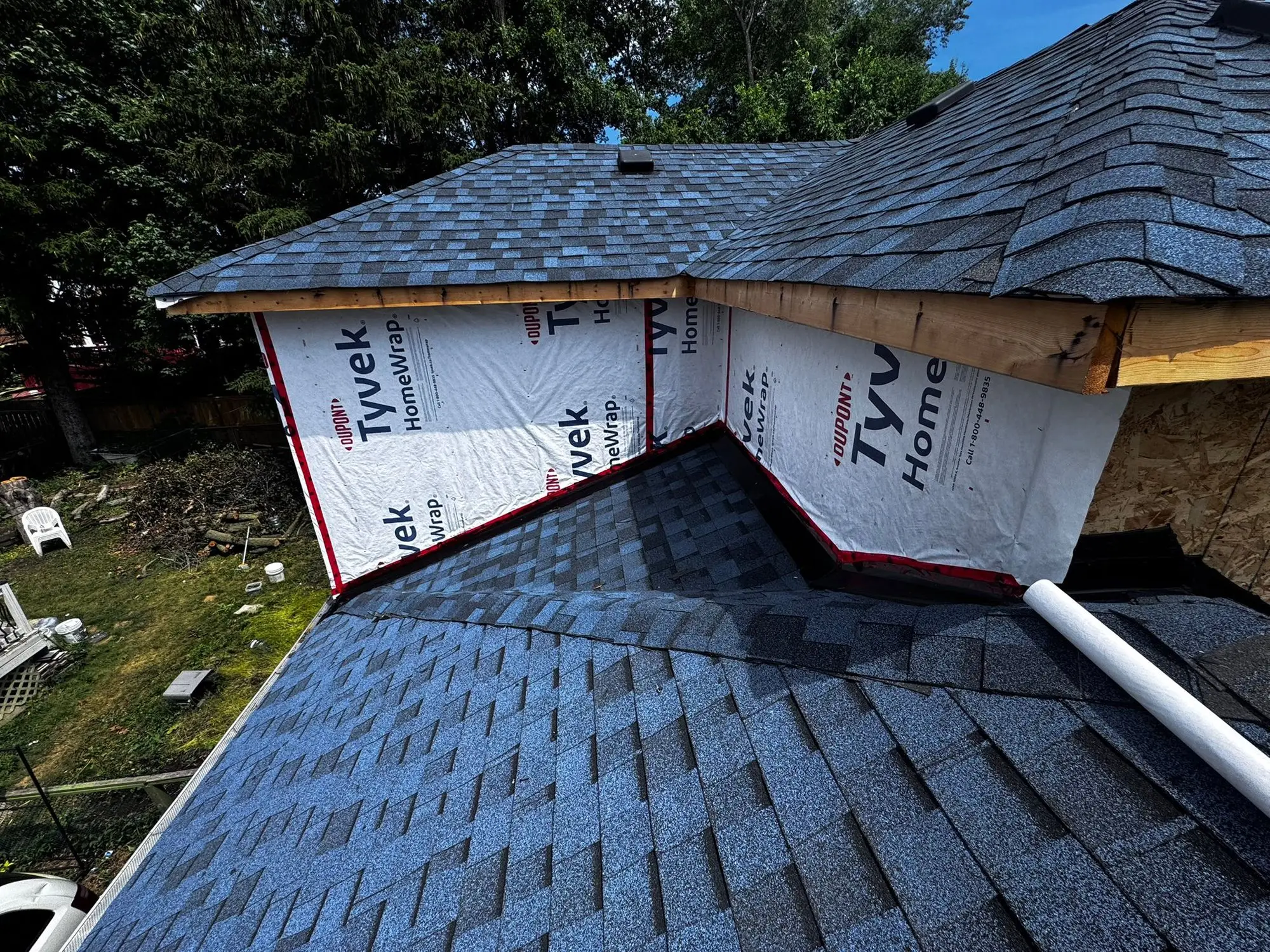 The new roof sheathed and shingled over the second storey