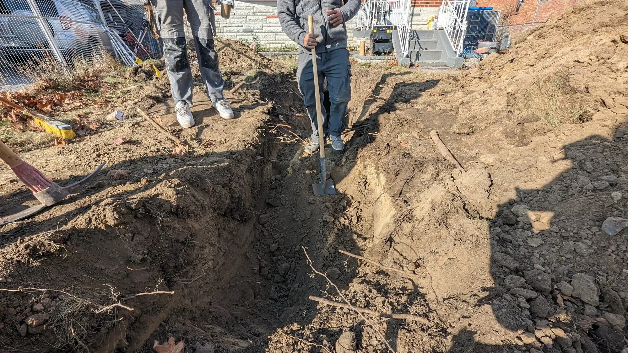 Trench dug from the street to run the new water service to the garden suite