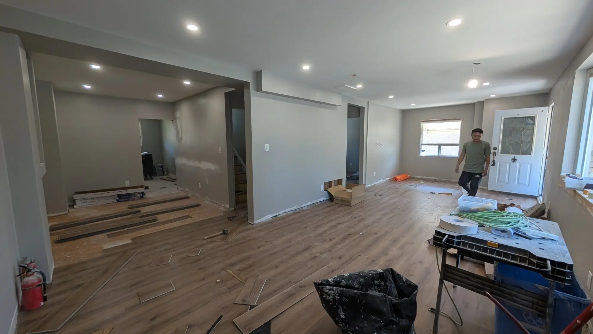 Vinyl plank flooring being installed through the main living space