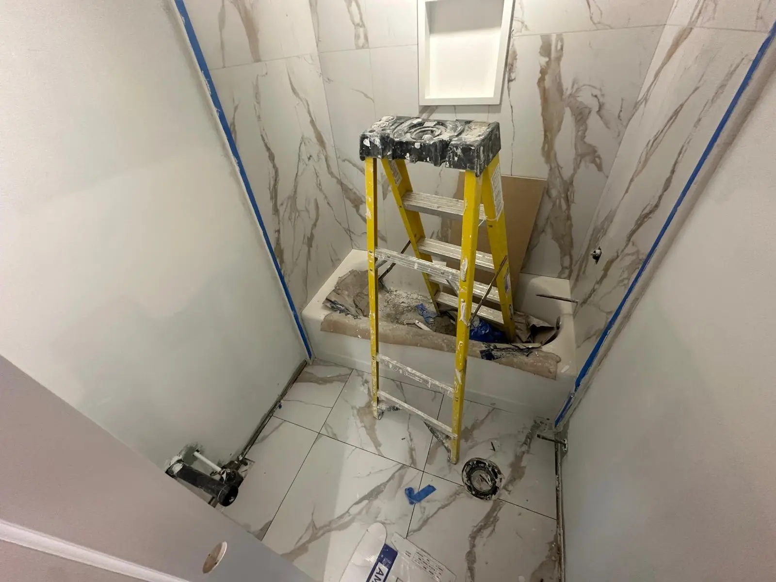 Large-format porcelain tile going up in one of the four new bathrooms