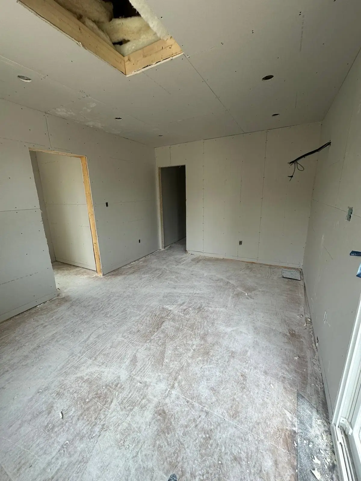 Rooms boarded out with drywall on the new upper level