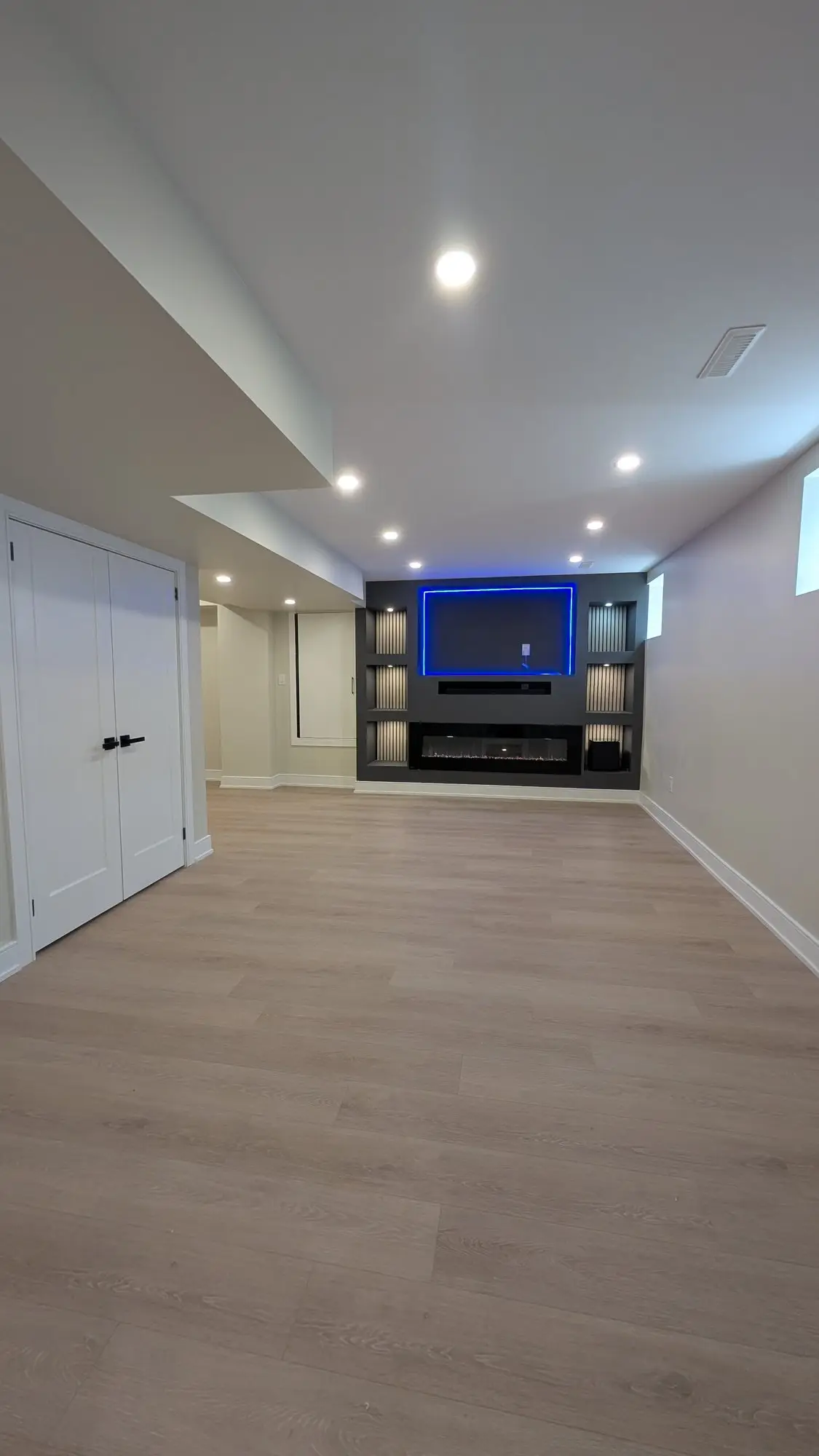 Finished basement corridor looking through to the rec room