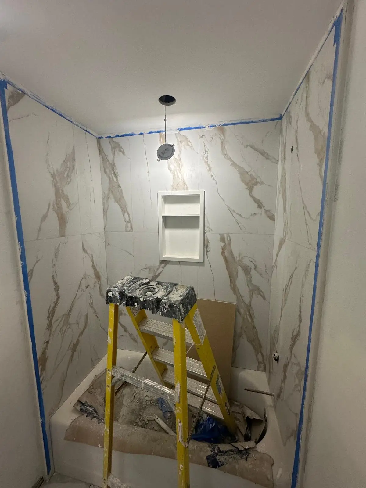 Tiled shower enclosure with the waterproofing complete behind it