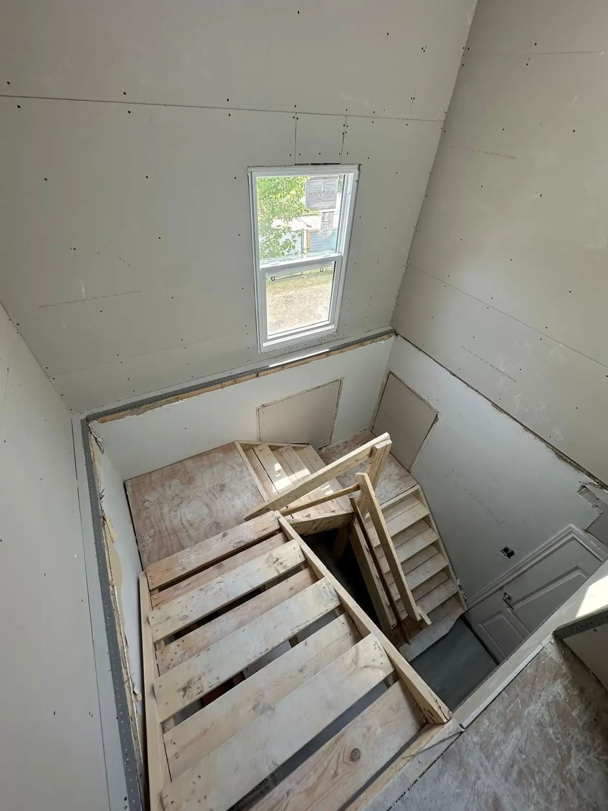 The new stair opening boarded, connecting the two levels
