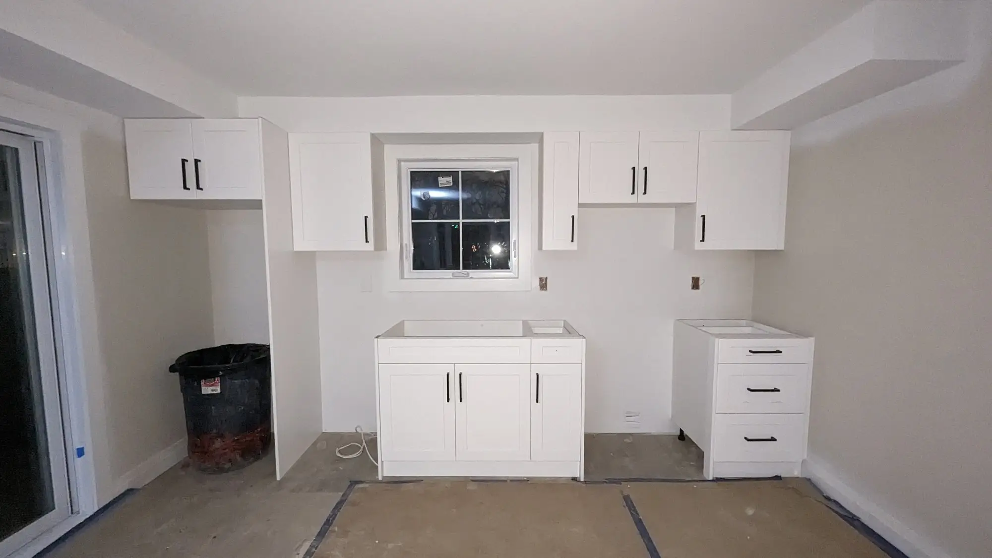 Base and upper cabinets set in the finished kitchen opening