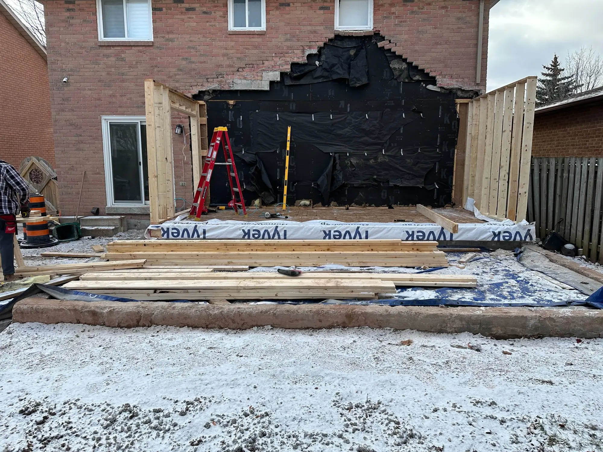 Weather membrane and wrap installed where the addition meets the original brick