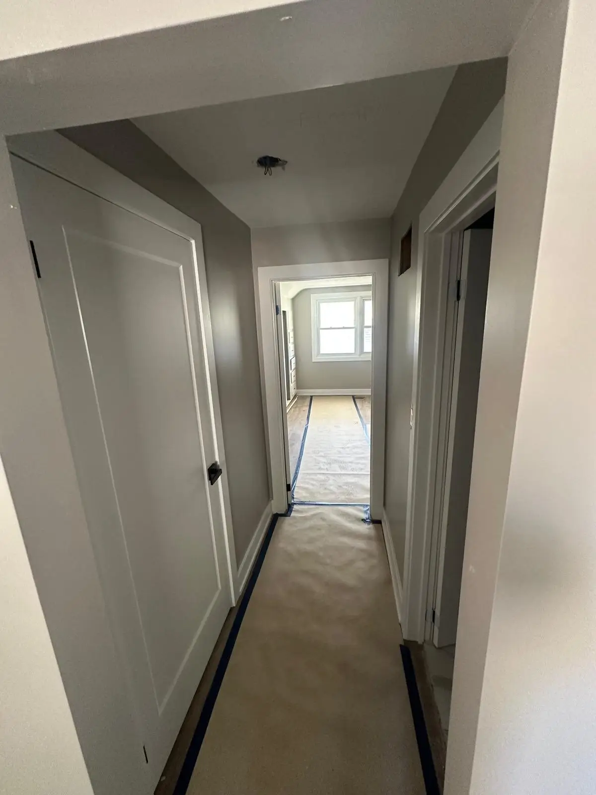 Completed hallway with new doors and trim through one of the units