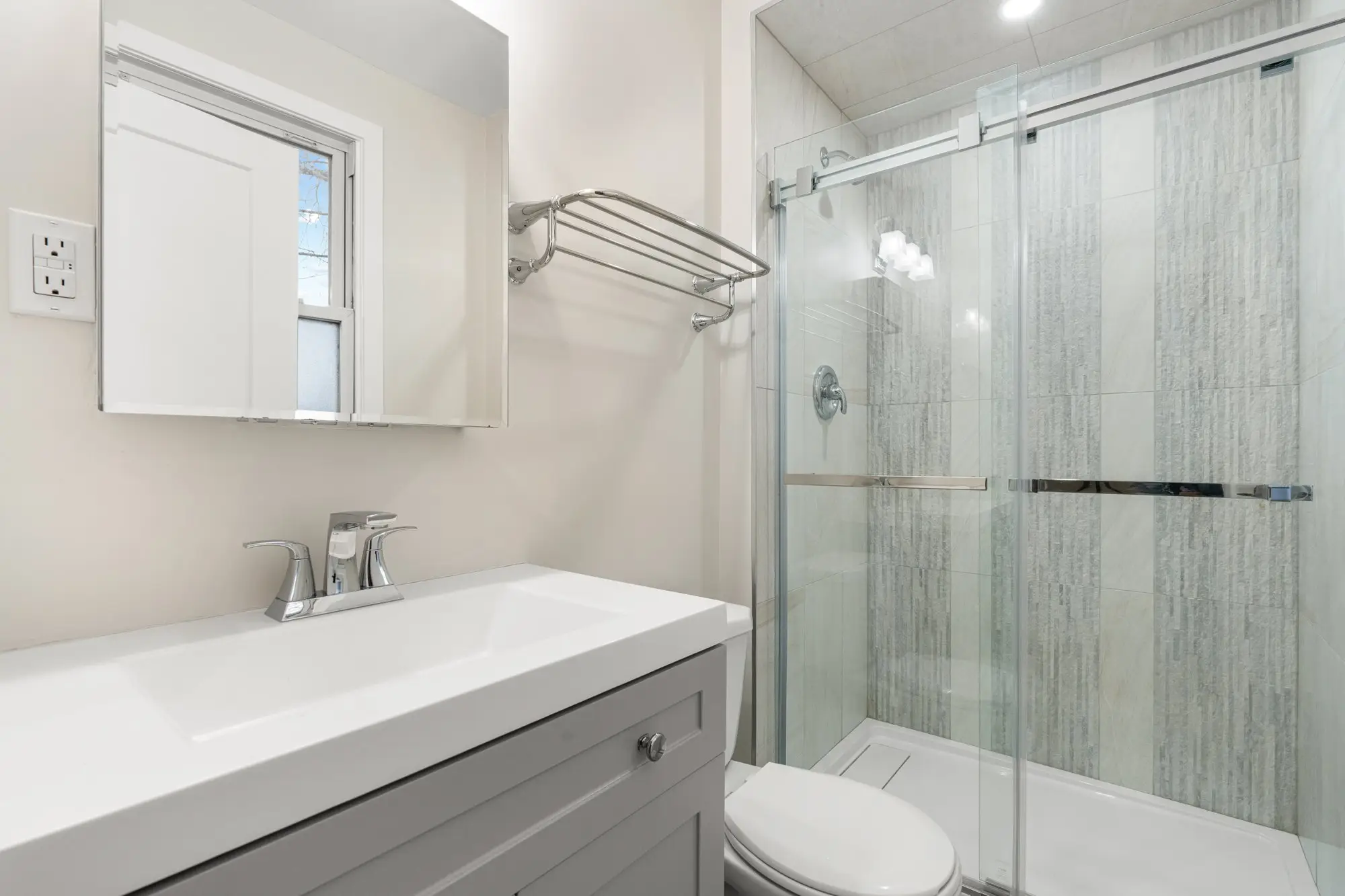 Second floor bathroom with glass shower and vanity