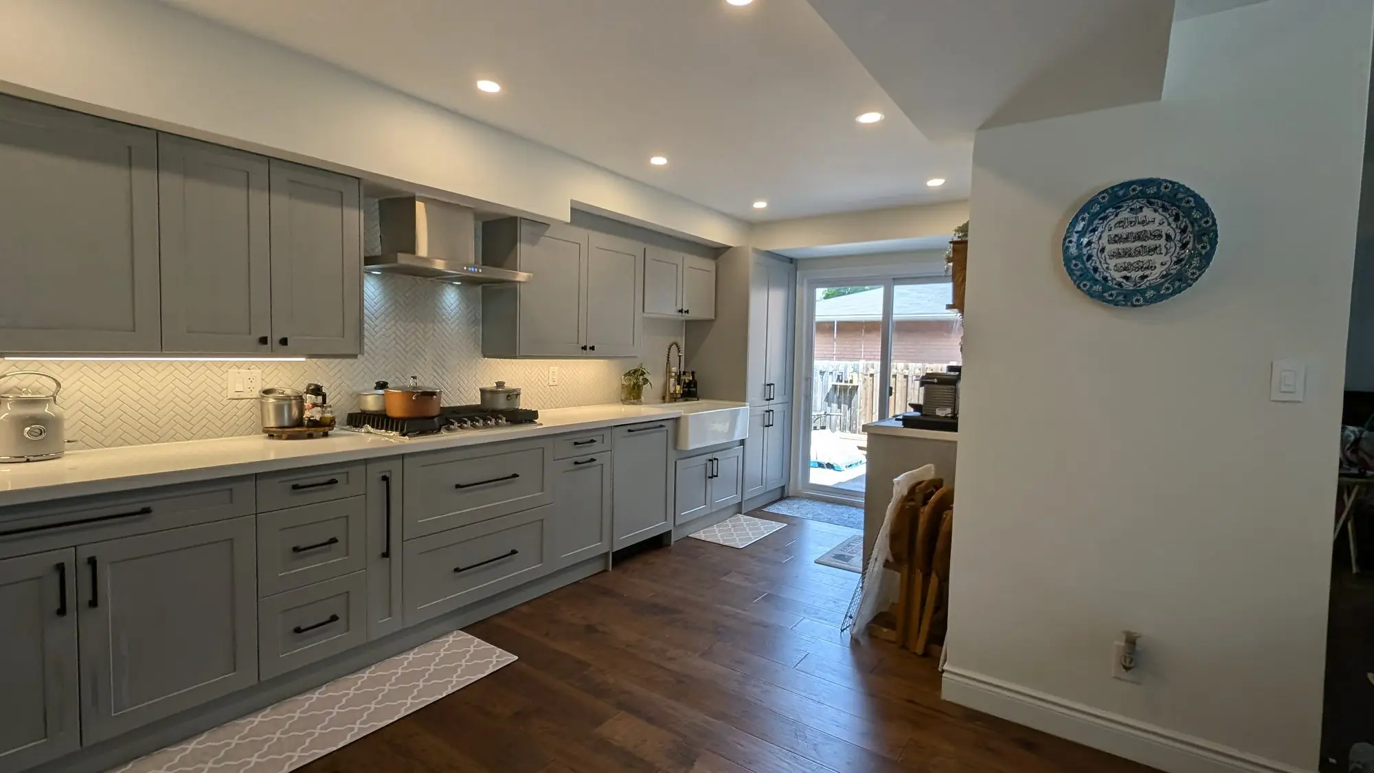 The finished kitchen running the full length of the space toward the rear door