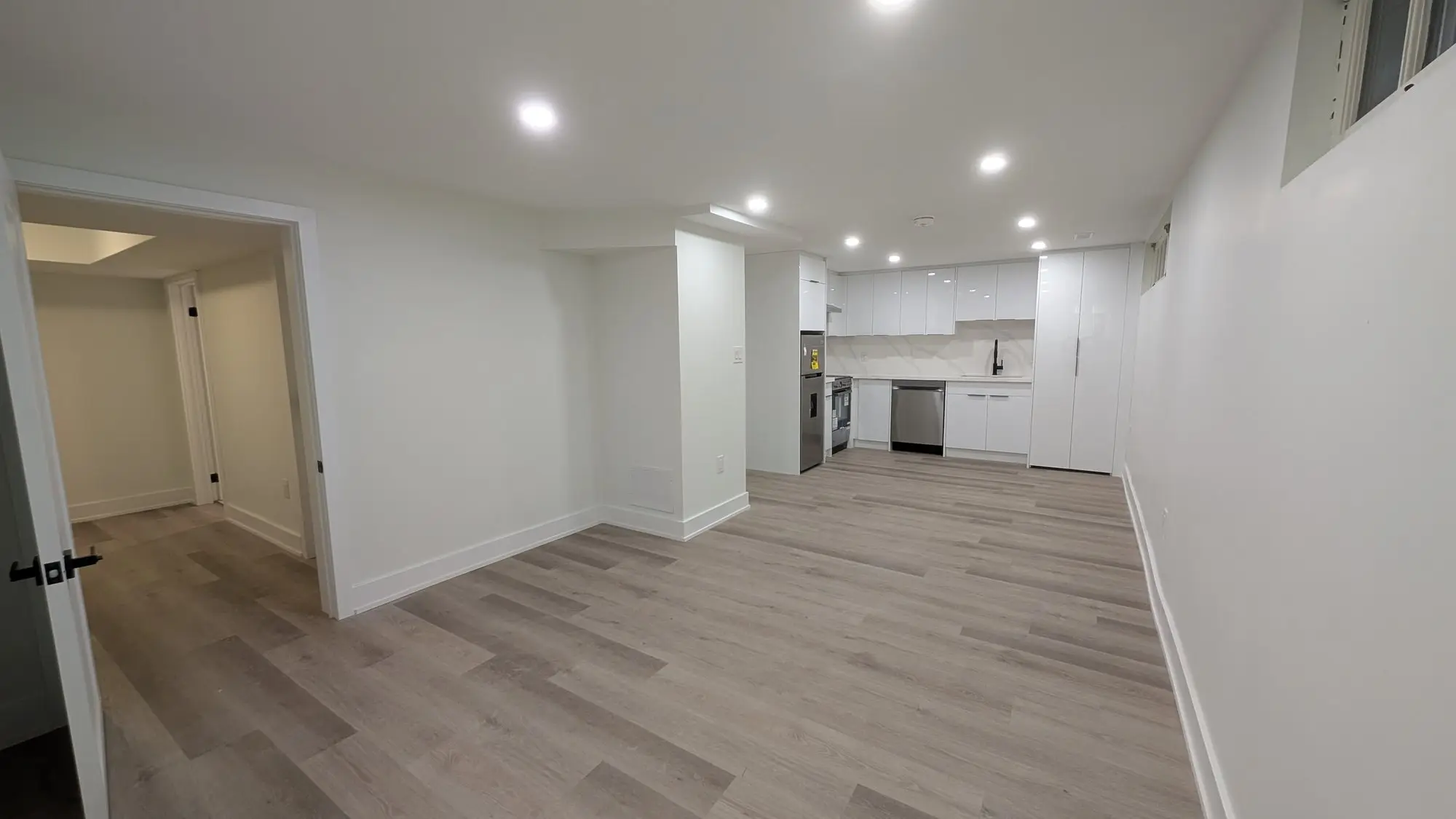 Finished open-plan living space looking through to the kitchen