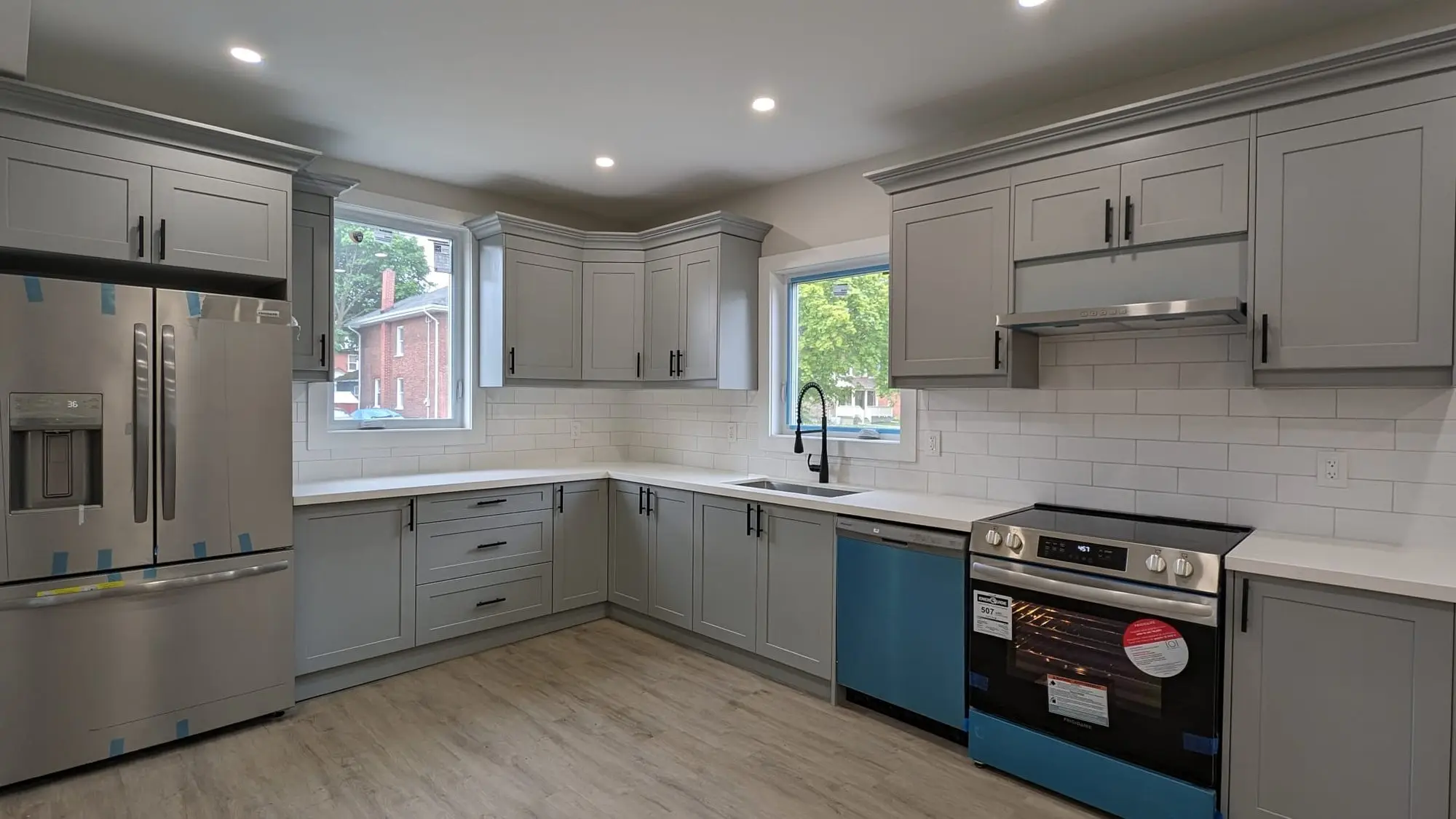 Kitchen range wall with quartz counter, subway backsplash and range hood
