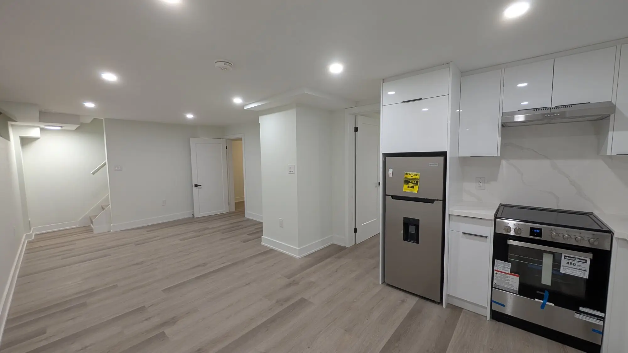 Wide view of the finished kitchen and living area