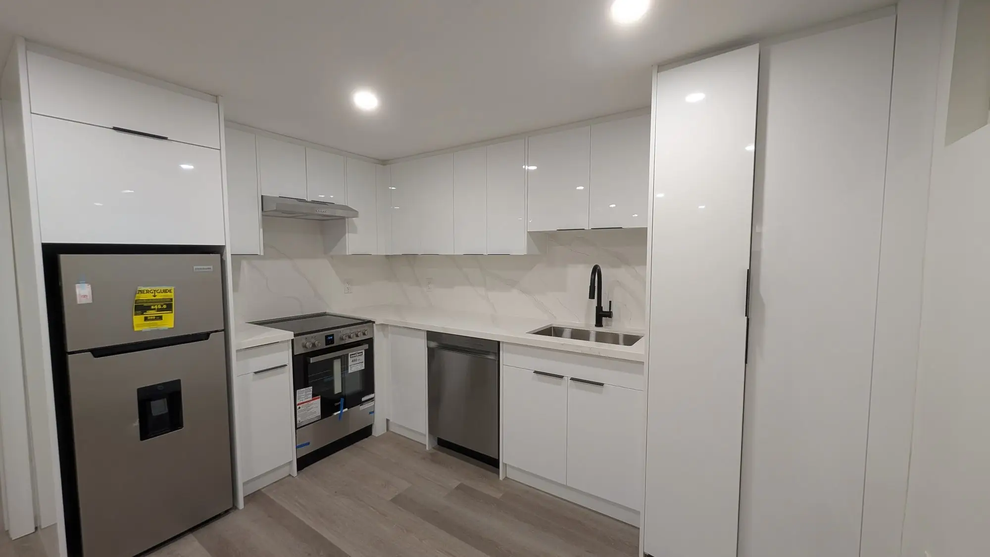 Kitchen detail with full-height cabinets and integrated appliances
