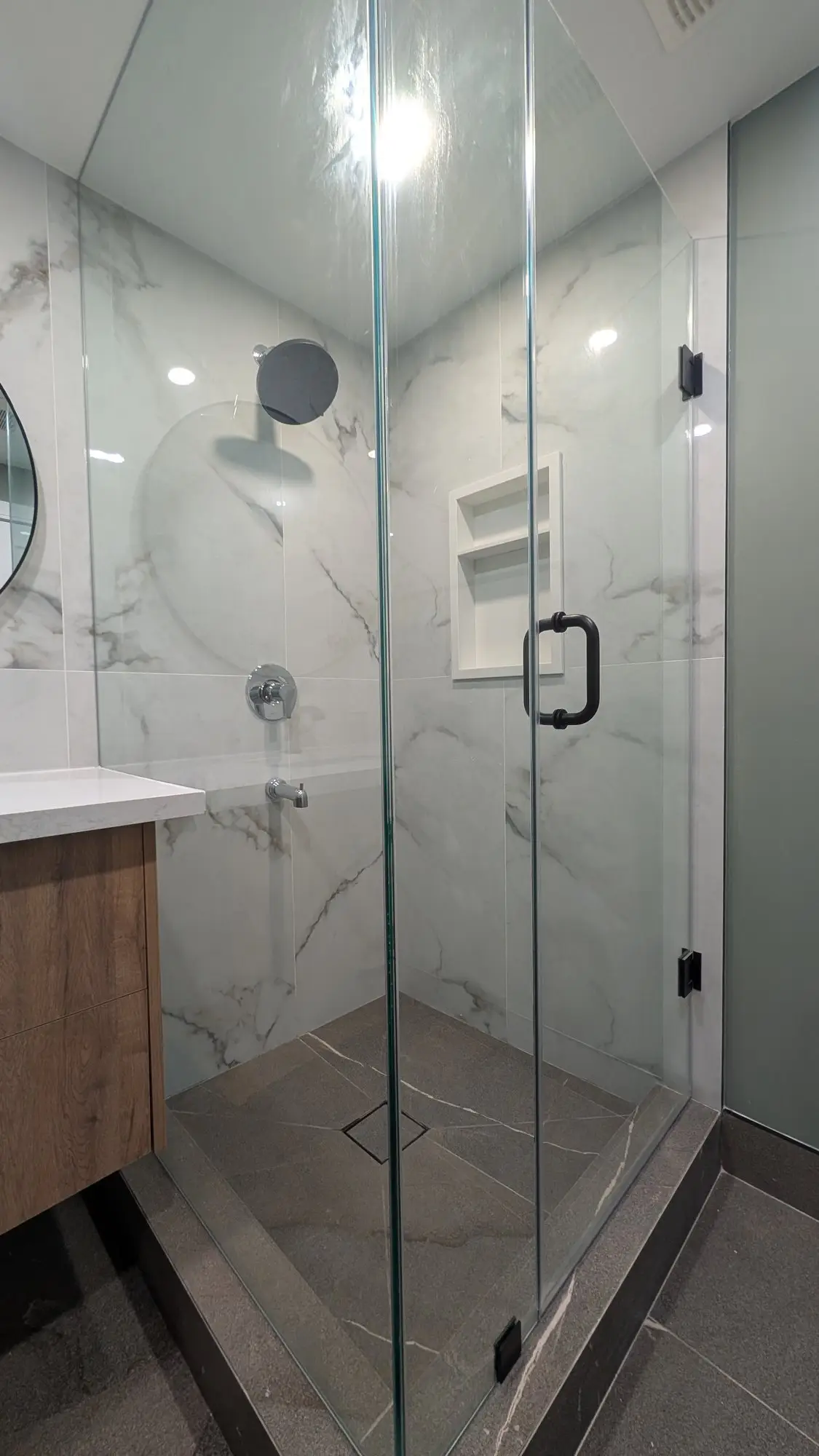 Wide view of the finished bathroom and shower enclosure
