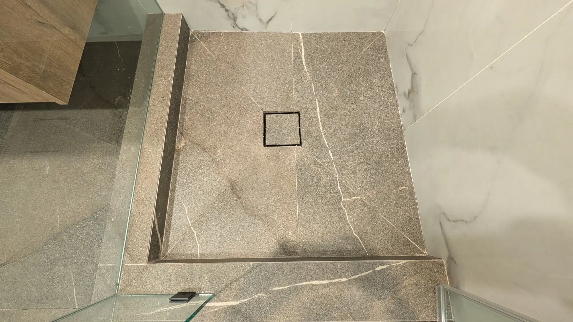 Curbless shower floor with linear drain and continuous large-format tile
