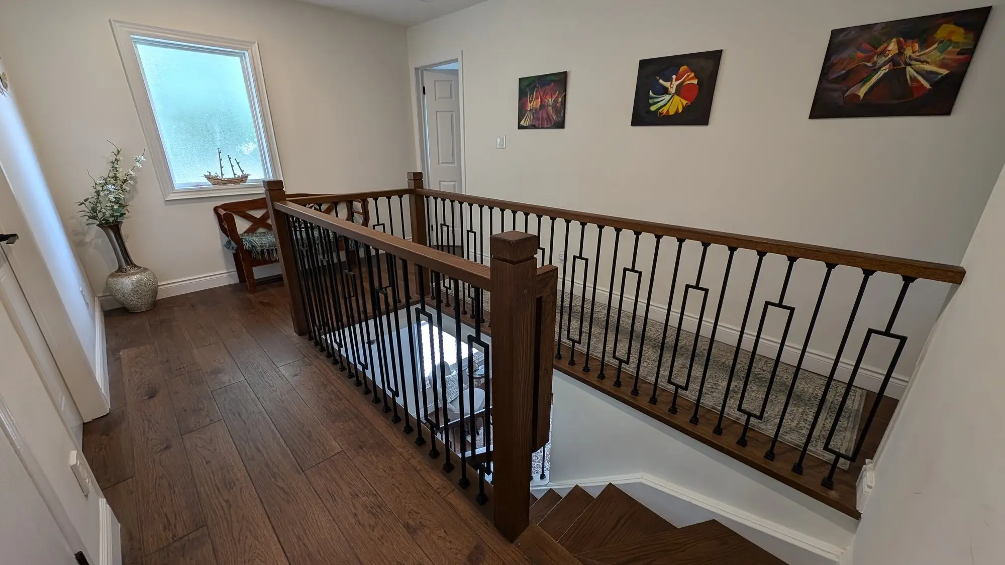 Upper landing and open rail overlooking the stairwell