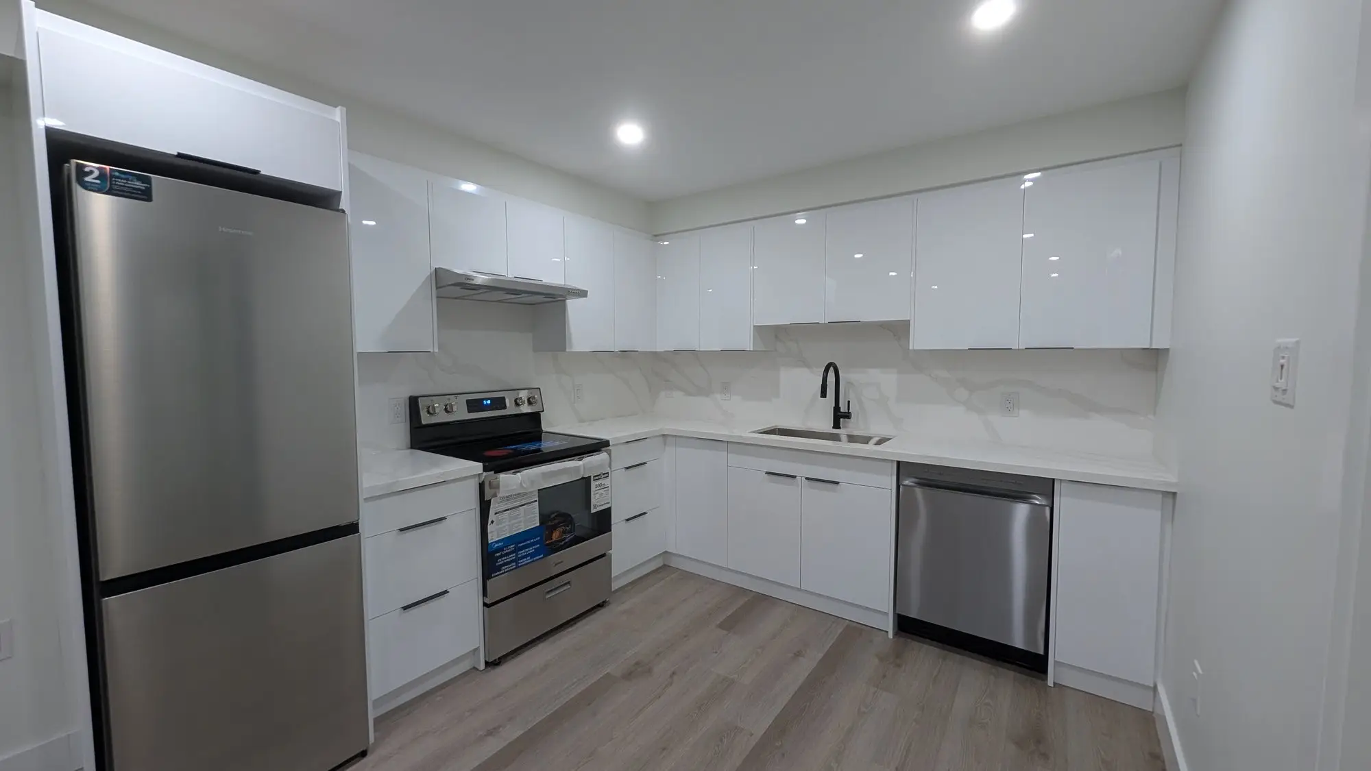 Wide view of the second unit kitchen and its living space