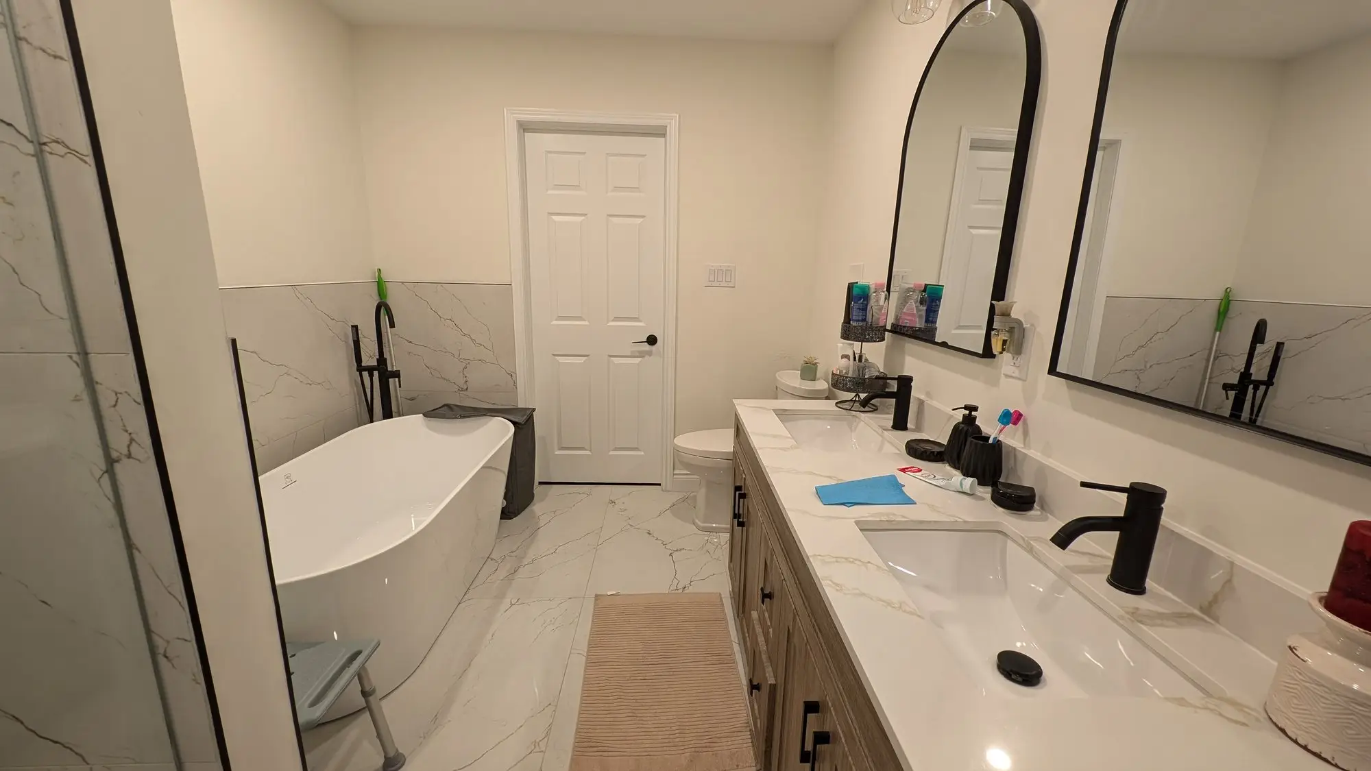 Main bathroom with freestanding tub, double vanity and full-height porcelain