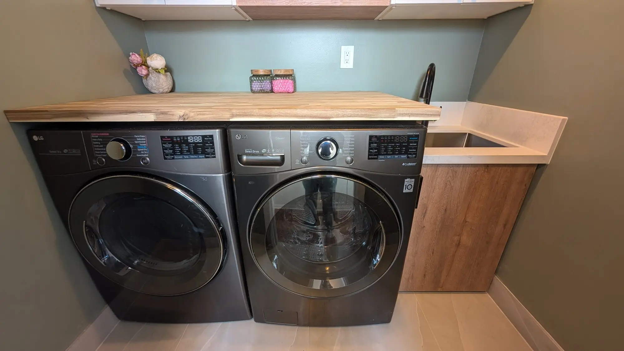 Finished laundry room with butcher-block counter over the machines