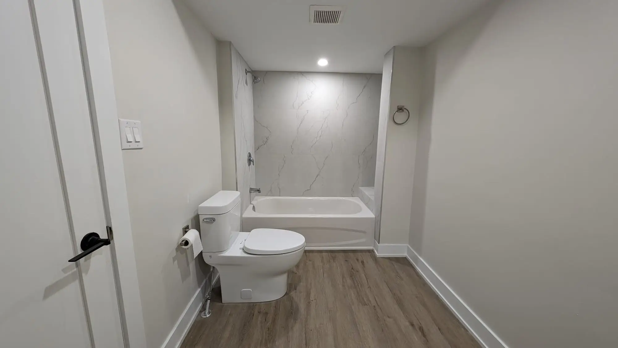Second bathroom with tub, tiled surround and new fixtures