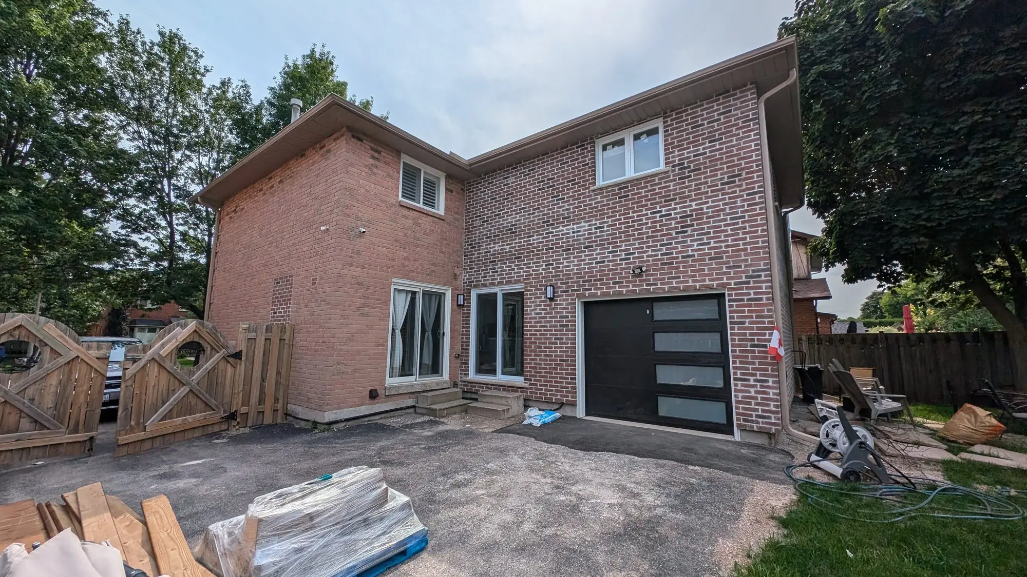 The completed addition in matching brick with a new garage door