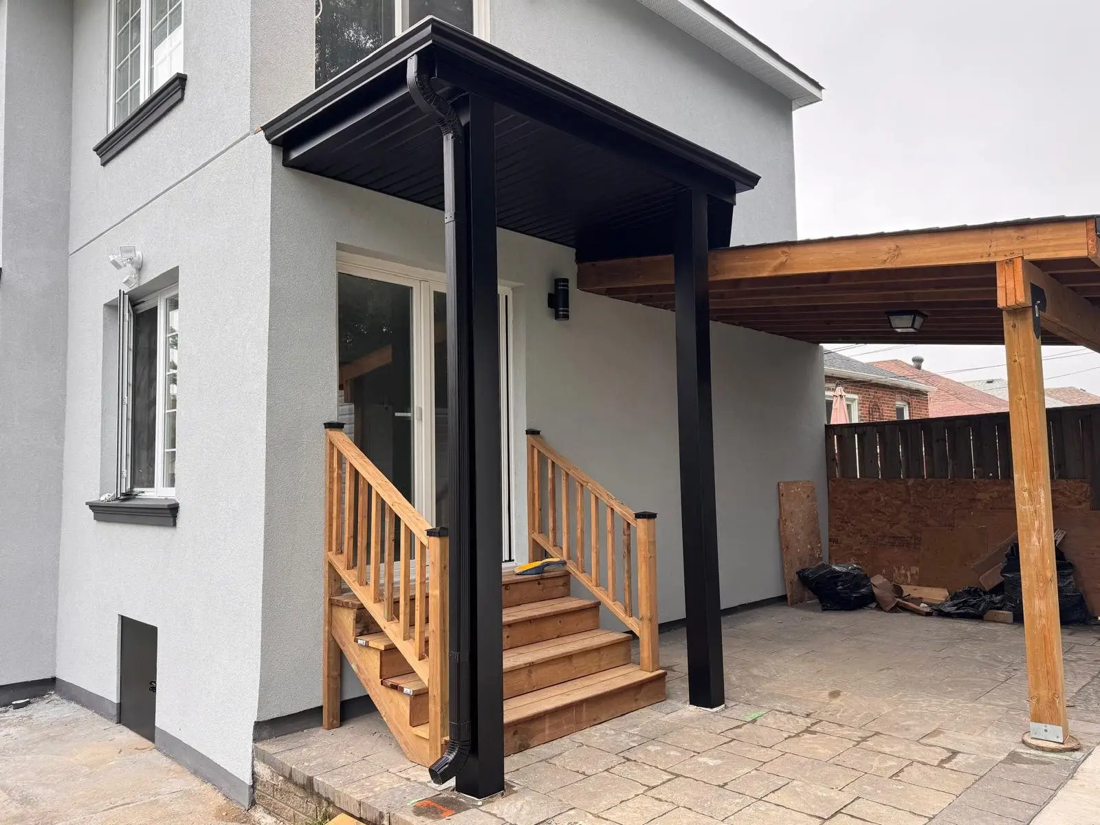 The finished entry and rear carport structure alongside the stucco exterior