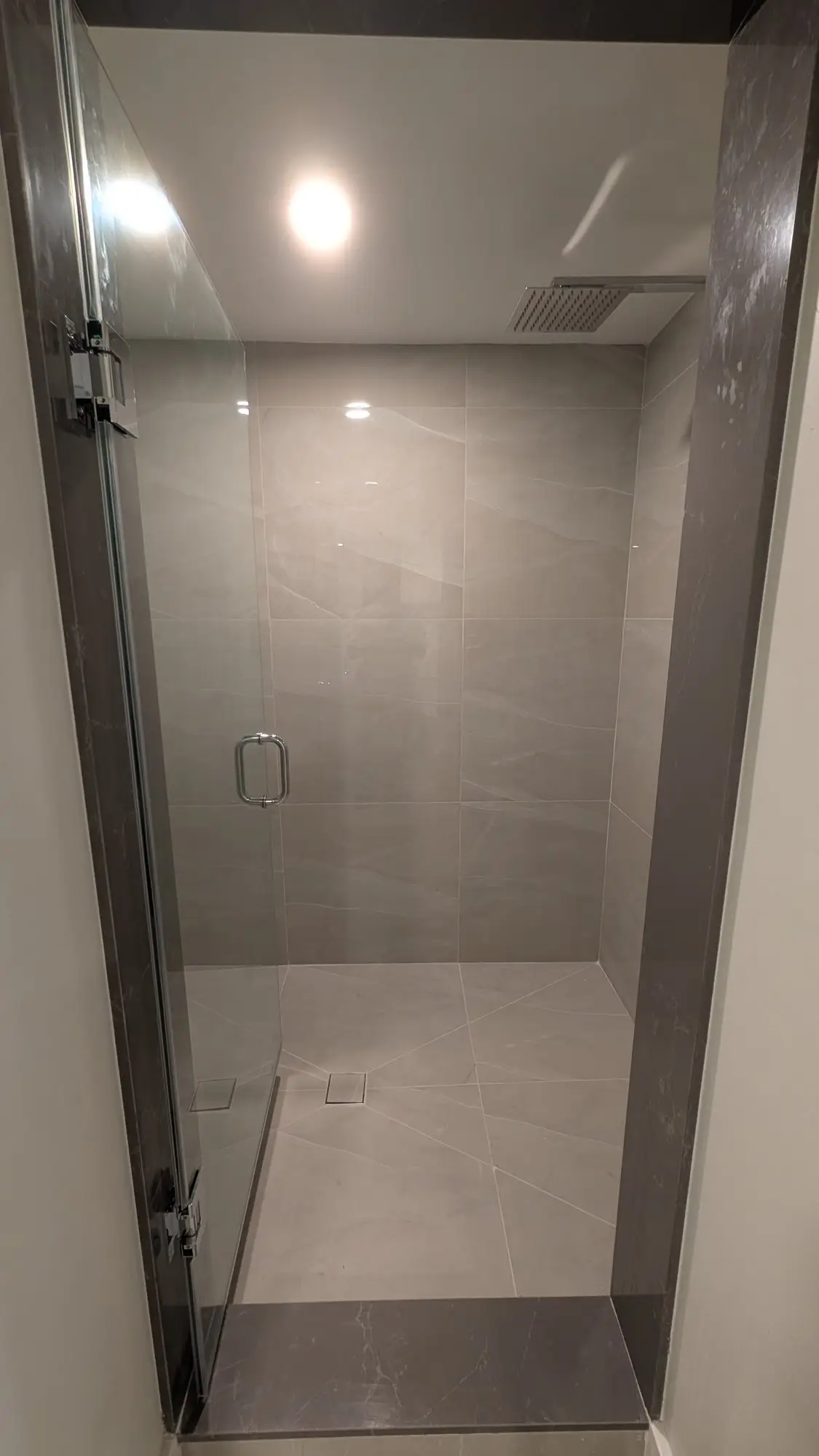 Completed tiled shower with glass enclosure