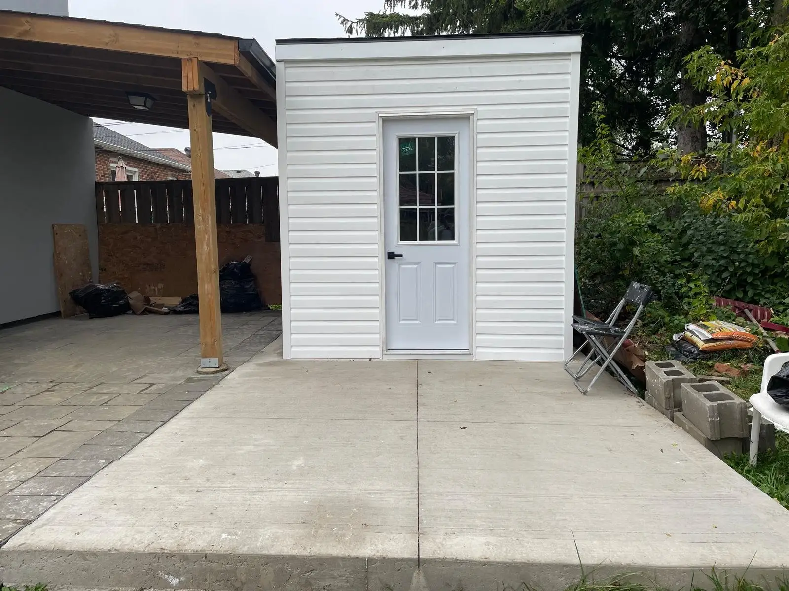 New concrete pad running back to the carport and outbuilding