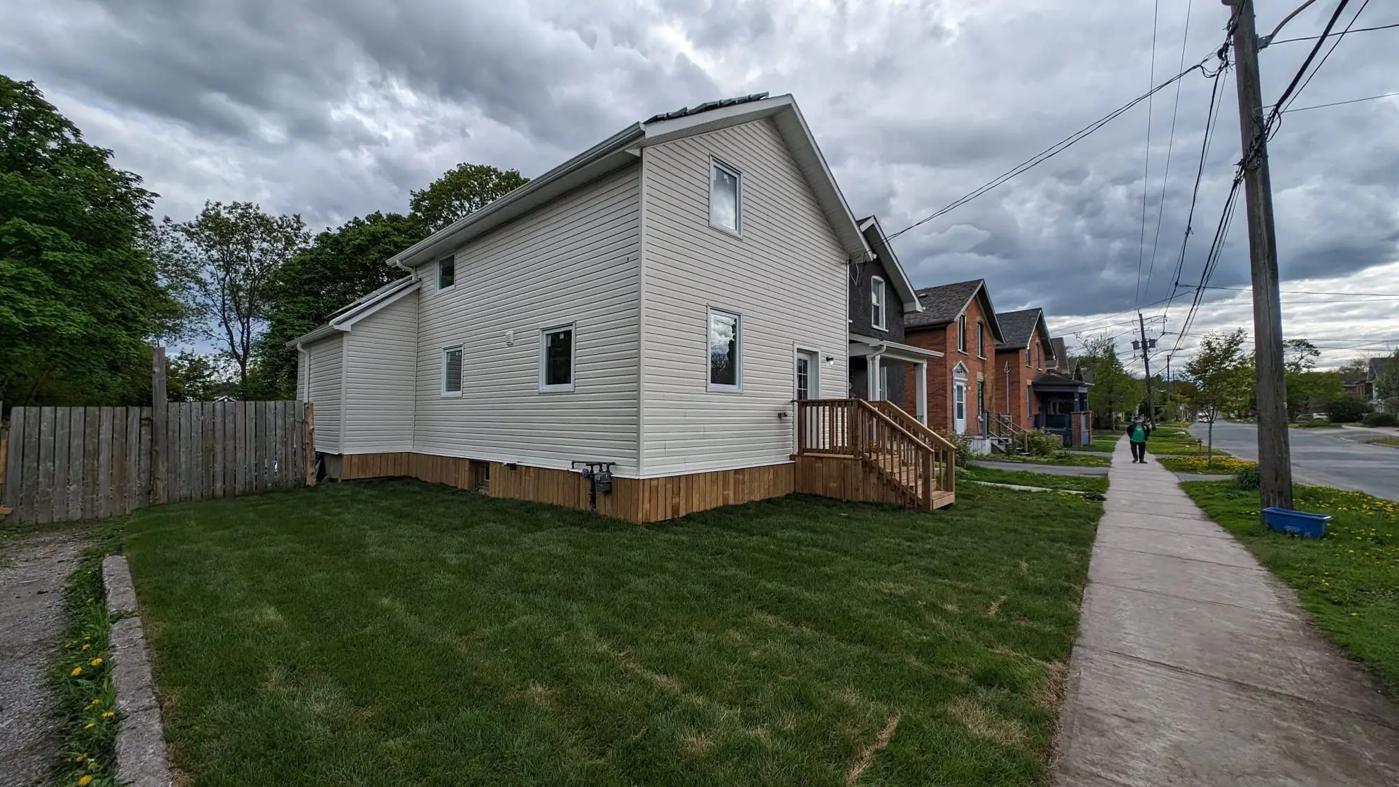 The completed century home from the side, siding and windows finished