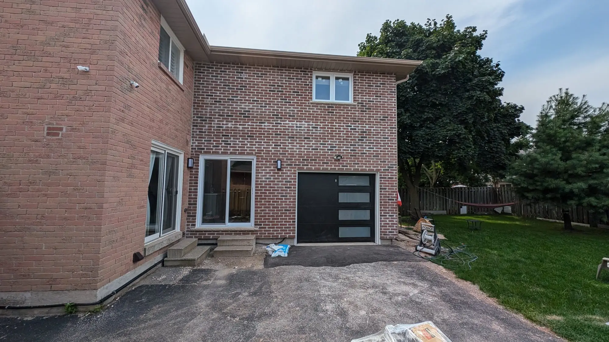 Wide view of the finished addition alongside the original house