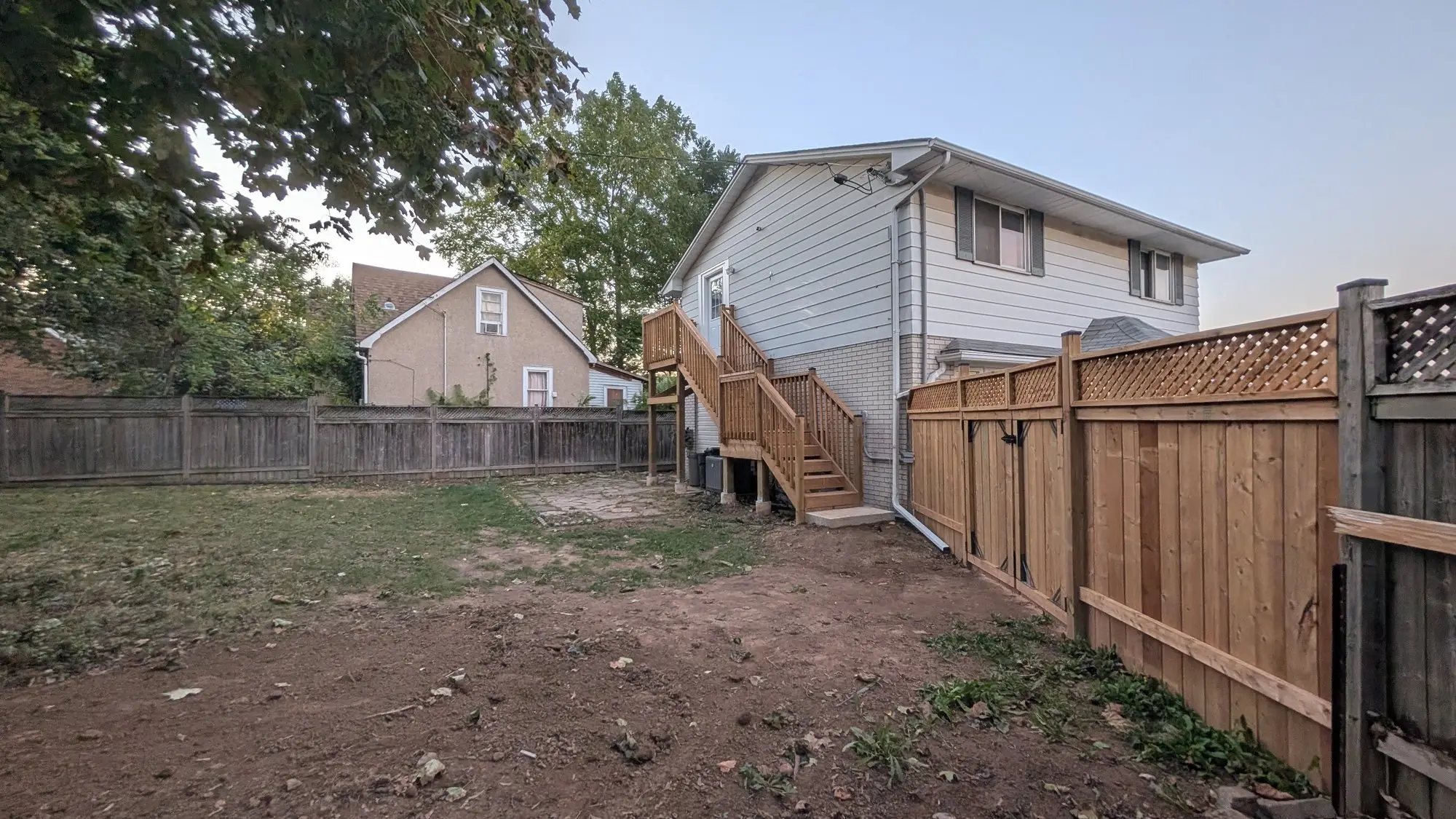 The rear of the finished house with the exterior stair to the upper entrance