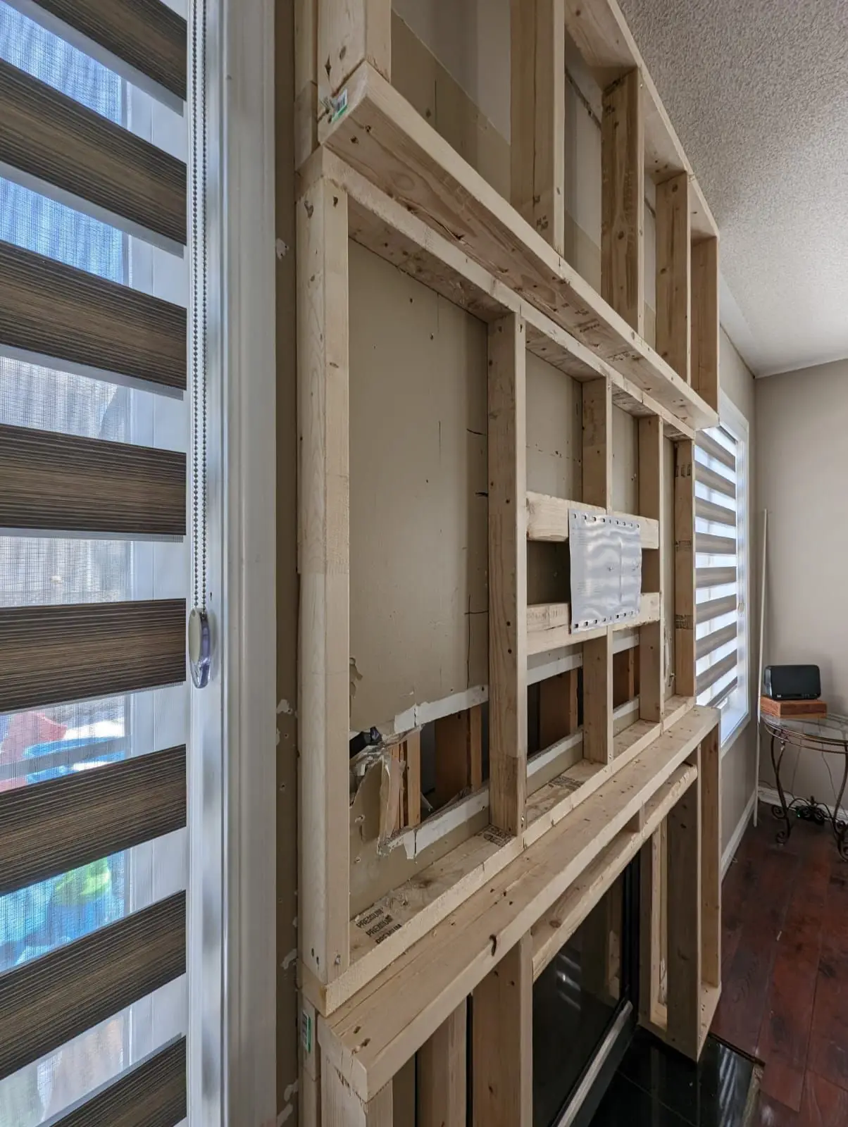 Framing & structure — Wooden framing structure built around a fireplace mantel in a living space.