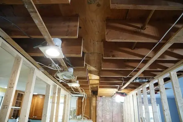 Rough-in — Basement ceiling framing and rough-in electrical work with pot lights installed.