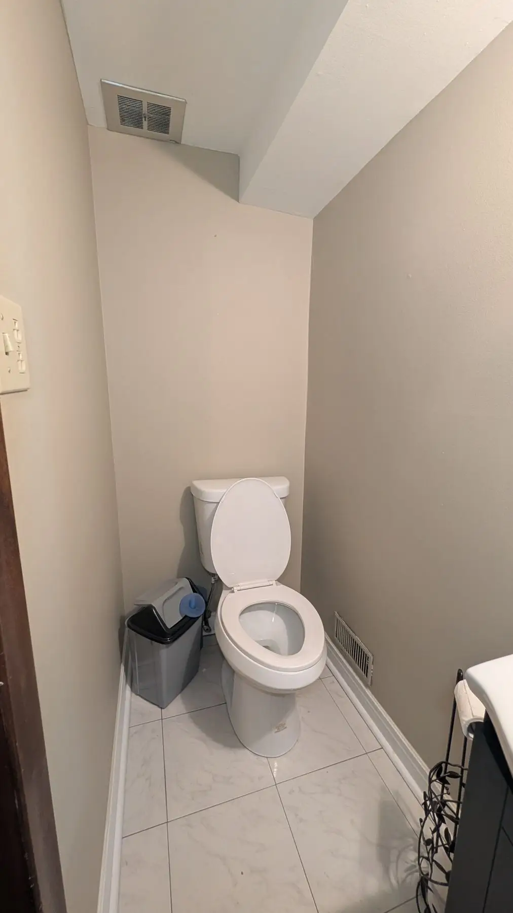 Finished — Finished small bathroom corner featuring a white toilet and tile flooring.