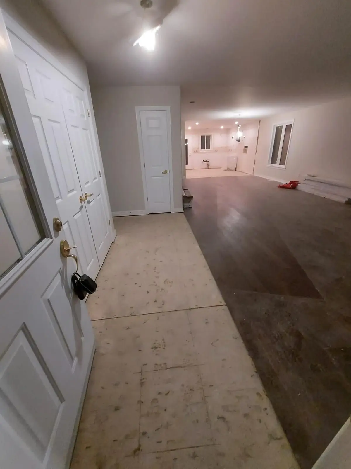 Finishing — Wide interior view from the front entryway looking into the unfinished living space and back rooms.